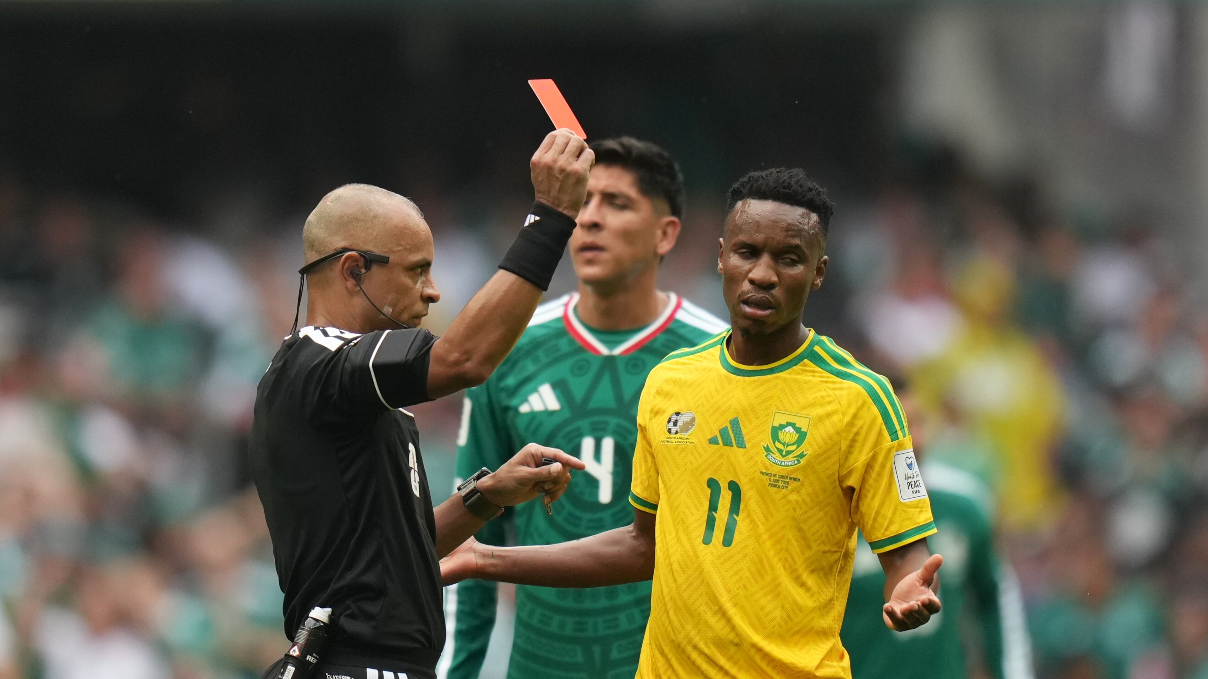Referee Wilton Sampaio, of Brazil, show the red card to South Africa's Themba Zwane during the World Cup Group A soccer match between Mexico and South Africa in Mexico City, Thursday, June 11, 2026. (AP Photo/Silvia Izquierdo)