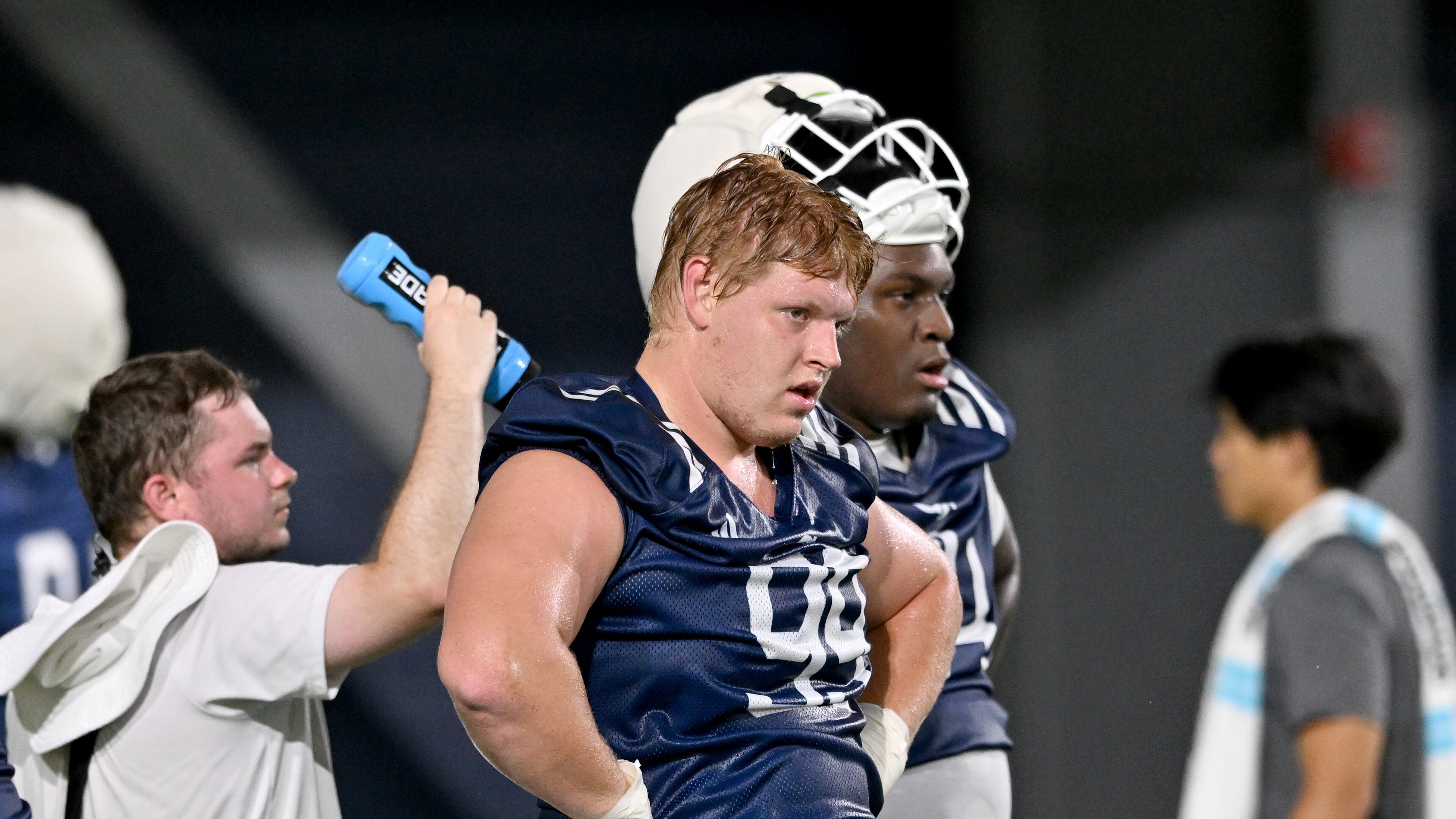 Jordan van den Berg (center), here cooling down during a July practice, returns to Georgia Tech's defensive line at tackle, but there will be several new starters along both lines of scrimmage for the Yellow Jackets. (Hyosub Shin/AJC)