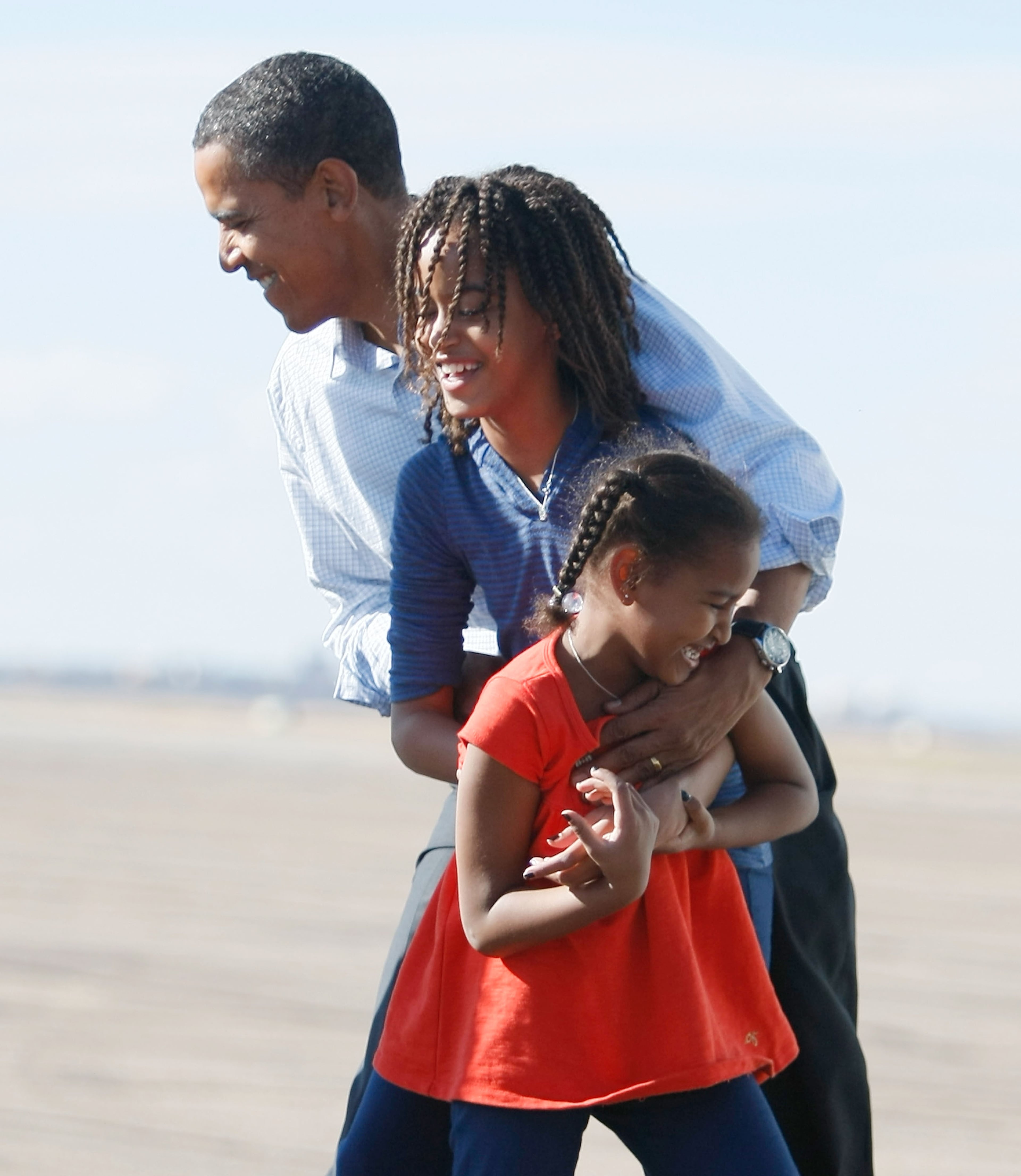 Democratic presidential nominee U.S. Sen. Barack Obama (D-IL) is greeted by his daughter, Malia (C) and Sasha as he exited his plane at Pueblo Memorial Airport November 1, 2008 in Pueblo, Colorado. Obama continues to campaign against Republican presidential nominee Sen. John McCain (R-AZ) as Election Day draws near. (Photo by Joe Raedle/Getty Images)