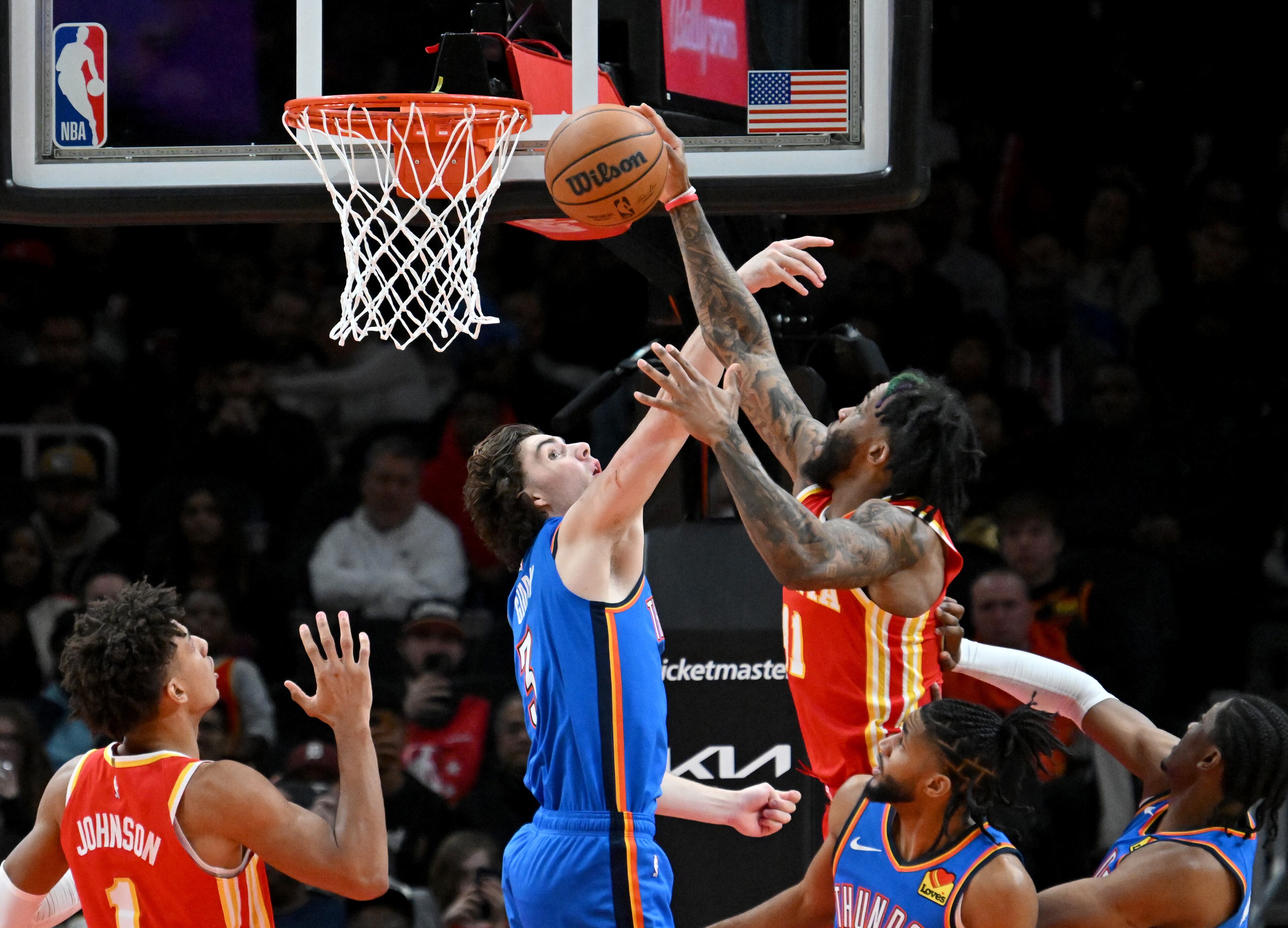 Atlanta Hawks forward Saddiq Bey (41) grabs a rebound over Oklahoma City Thunder guard Josh Giddey (3) during the second half in an NBA basketball game at State Farm Arena, Wednesday, December 3, 2024, in Atlanta. Atlanta Hawks won 141-138 over Oklahoma City Thunder. (Hyosub Shin / Hyosub.Shin@ajc.com)