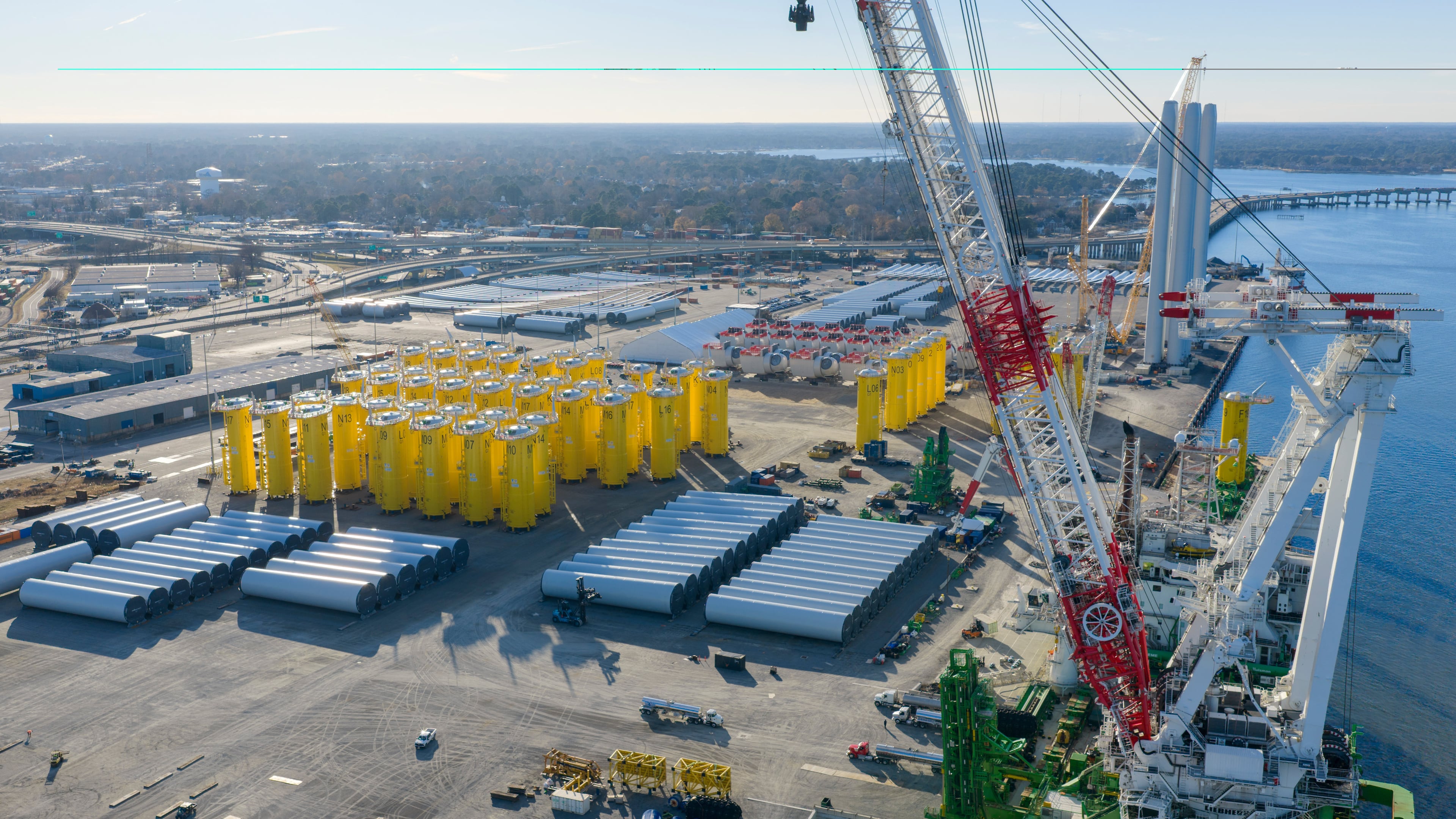 FILE - Wind turbine bases, generators and blades sit along with support ships at The Portsmouth Marine terminal that is the staging area for Dominion Energy Virginia, which is developing Coastal Virginia Offshore Wind, Dec. 22, 2025, in Portsmouth, Va. (AP Photo/Steve Helber, File)