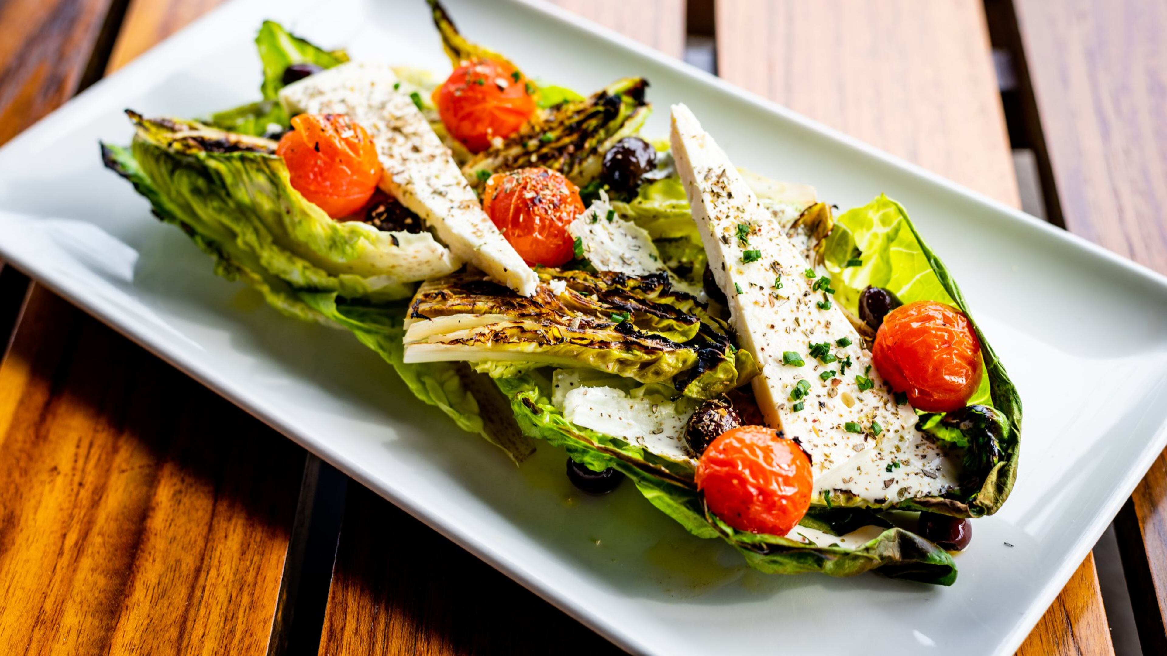 Grilled baby gem salad at Drift Fish House and Oyster Bar. CONTRIBUTED BY HENRI HOLLIS