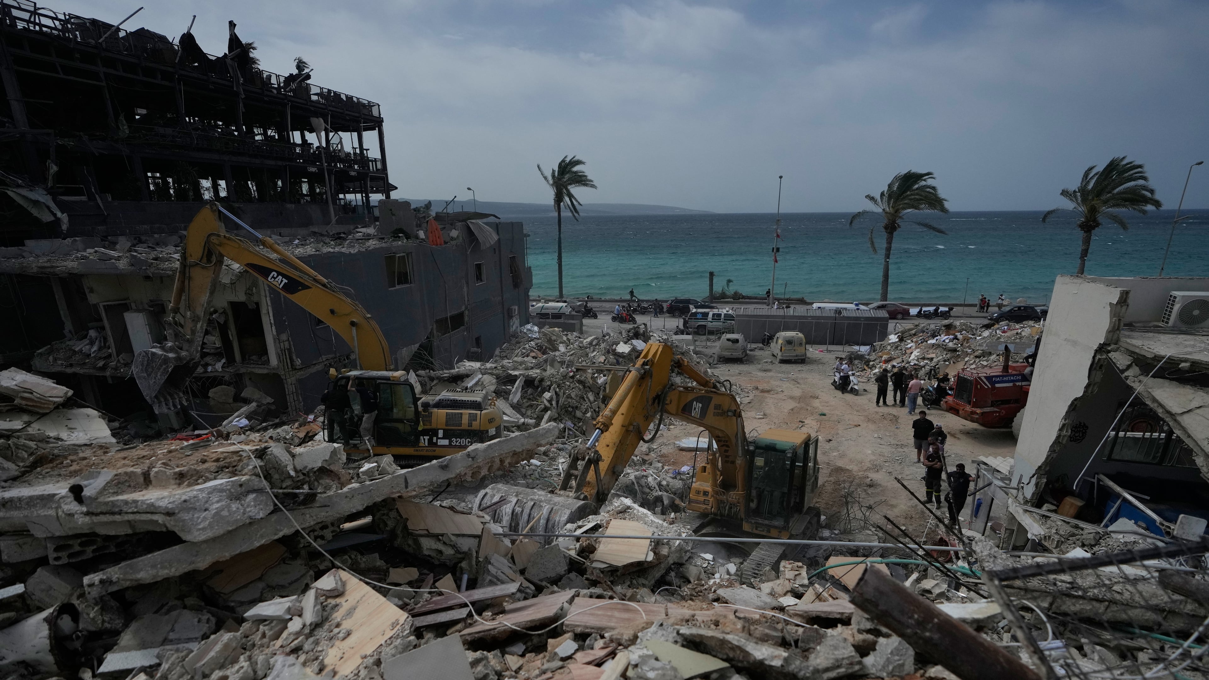 Rescuers search for victims in the rubble of a destroyed building that was struck in Israeli airstrikes in the city of Tyre, south Lebanon, Friday, April 17, 2026. (AP Photo/Mohammed Zaatari)