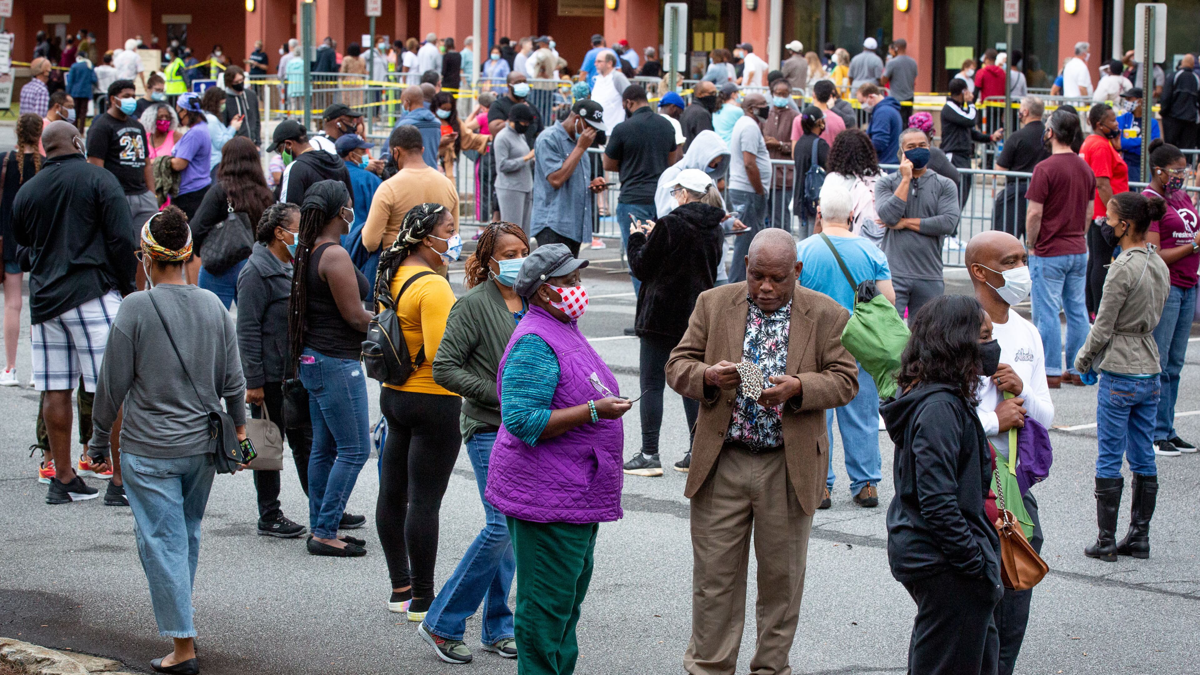 Long lines form outside the Cobb County Board of Elections and Registration offices on Monday for the first day of early voting. STEVE SCHAEFER / SPECIAL TO THE AJC