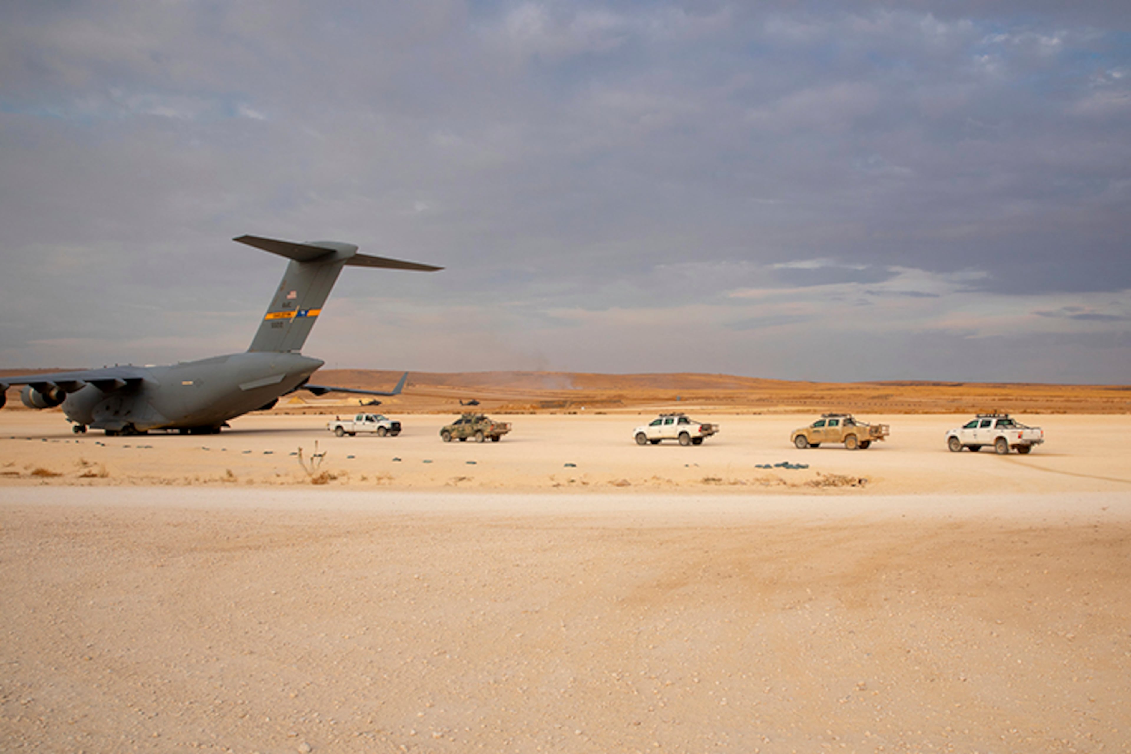 In this Oct. 25 photo, released by the U.S. Army Reserve, vehicles lined up to be loaded onto a cargo plane as part of the deliberate withdrawal of coalition forces from northern Syria at the Kobani Landing Zone (KLZ).