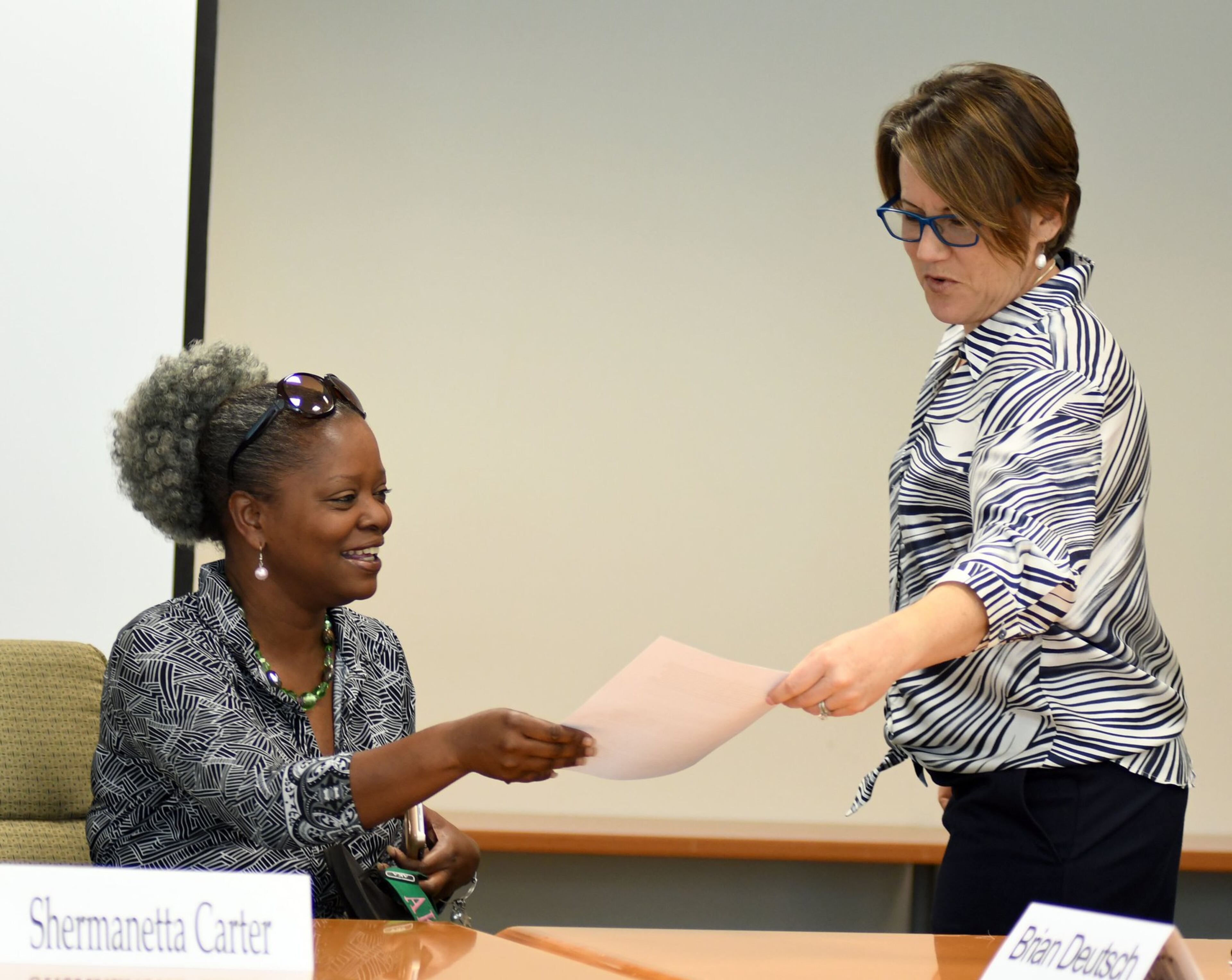 DeKalb County Board of Ethics member Shermanetta Carter (left) and Ethics Officer Stacey Kalberman talk before the DeKalb Board of Ethics meeting on August 1, 2017.