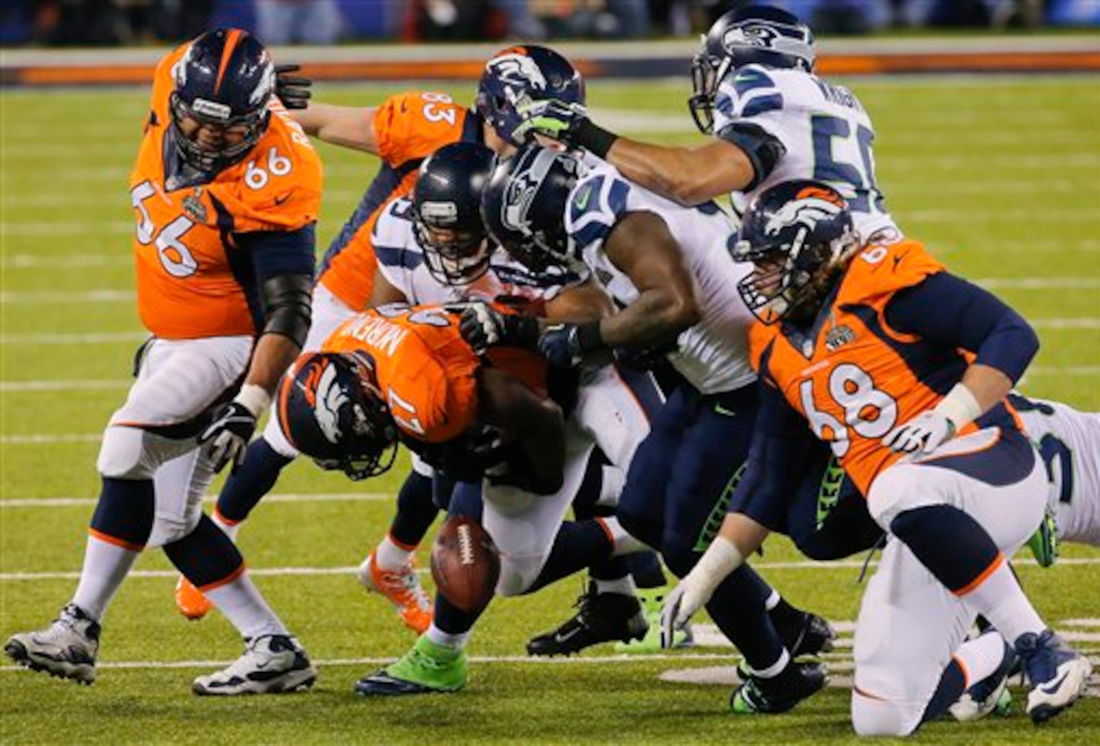 Denver Broncos running back Knowshon Moreno (27) fumbles the ball against the Seattle Seahawks during the first half of the NFL Super Bowl XLVIII football game, Sunday, Feb. 2, 2014, in East Rutherford, N.J. (AP Photo/Matt York)
