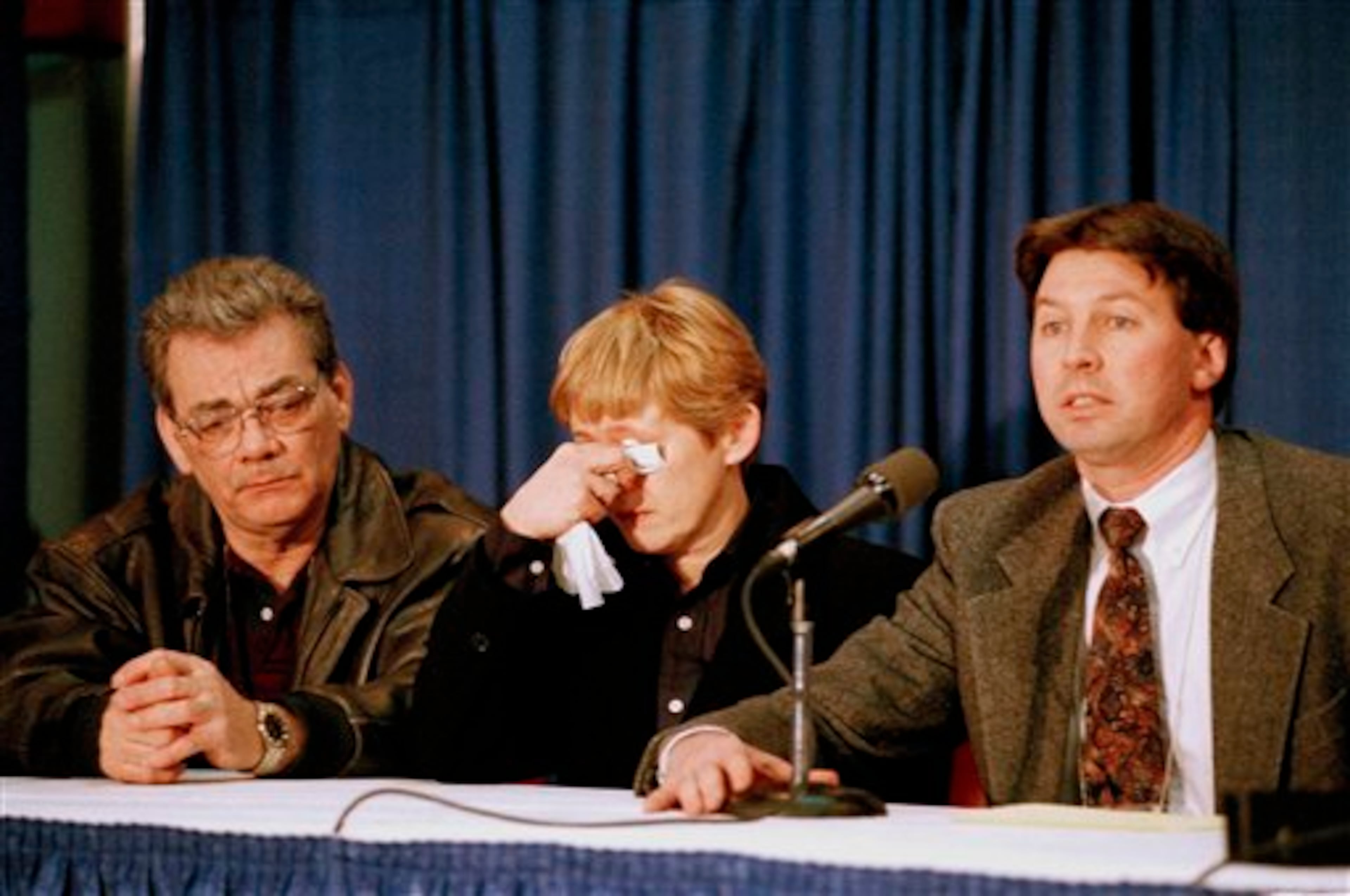 Dan and Brenda Kerrigan listen to Dr. Mahlon Bradley address a news conference at Joe Louis Arena in Detroit, Mich., Jan. 7, 1994. Bradley explained the medical condition of their daughter Nancy Kerrigan, a figure skater from Stoneham, Mass., who was attacked Thursday after practicing for the U.S. Figure Skating Championships. Kerrigan withdrew from competition as a result of her injuries. (AP Photo/Lennox McLendon)