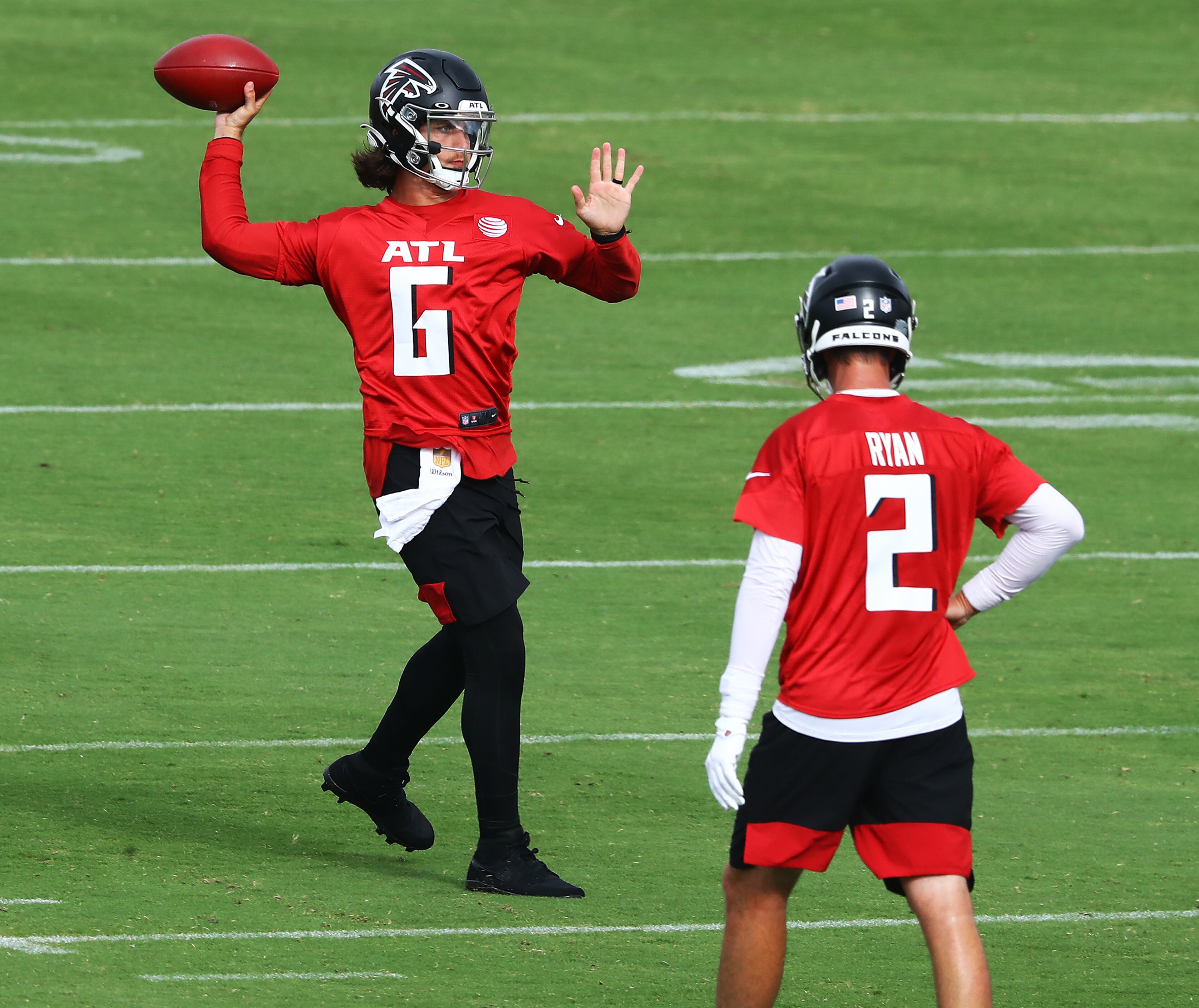Falcons backup quarterback Kurt Benkert completes a pass with Matt Ryan looking on during training camp on Saturday, August 15, 2020 in Flowery Branch. Curtis Compton ccompton@ajc.com