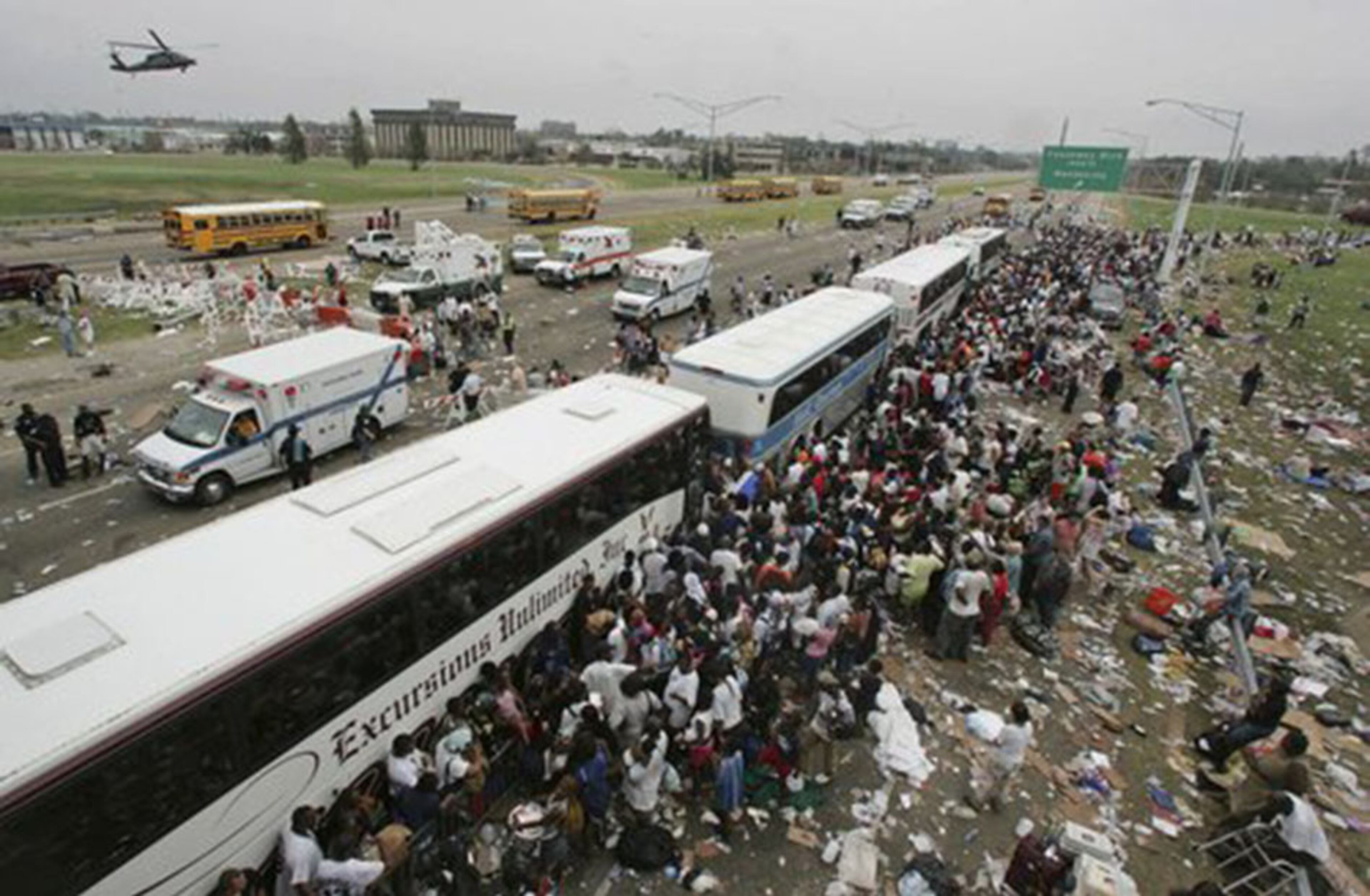 New Orleans residents gather at a evacuation staging area along Interstate 10 in Metarie, La. The residents were either evacuated by air or walked to the Interstate to escape the city besieged by flooding and lack of electricity in the wake of Hurricane Katrina.