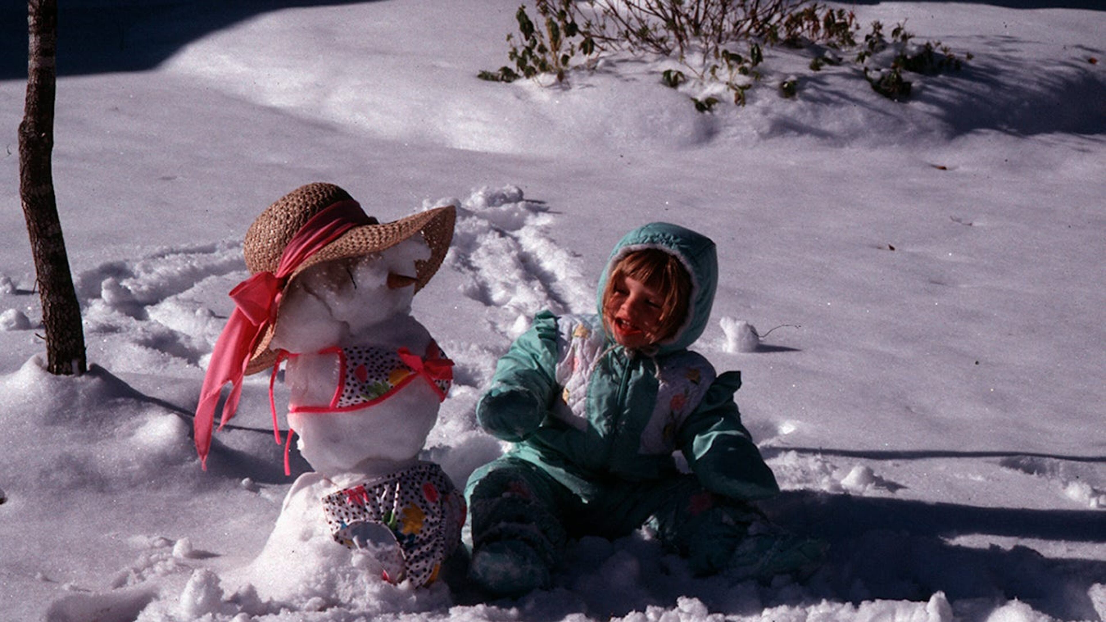 Kristine Topmiller plays with her snowgirl on Wilmington Island in this December 1989 photo.