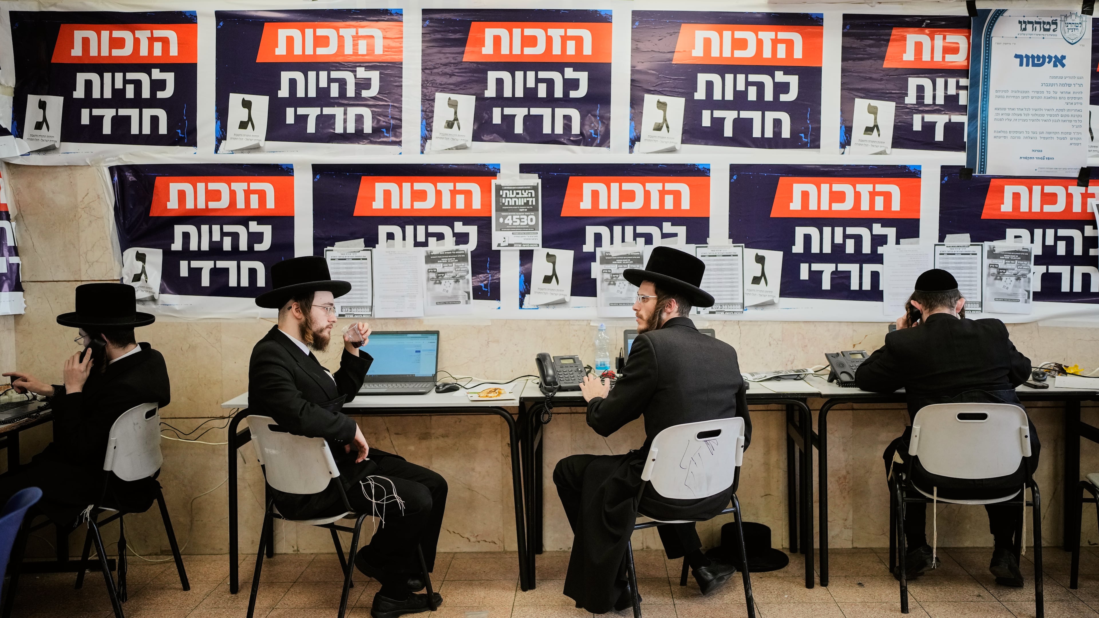 Ultra-Orthodox Jewish men work at the United Torah Judaism (Yahadut HaTorah) party headquarters during Israel's general election in Jerusalem, Tuesday, Oct. 27, 2026. (AP Photo/Ohad Zwigenberg)