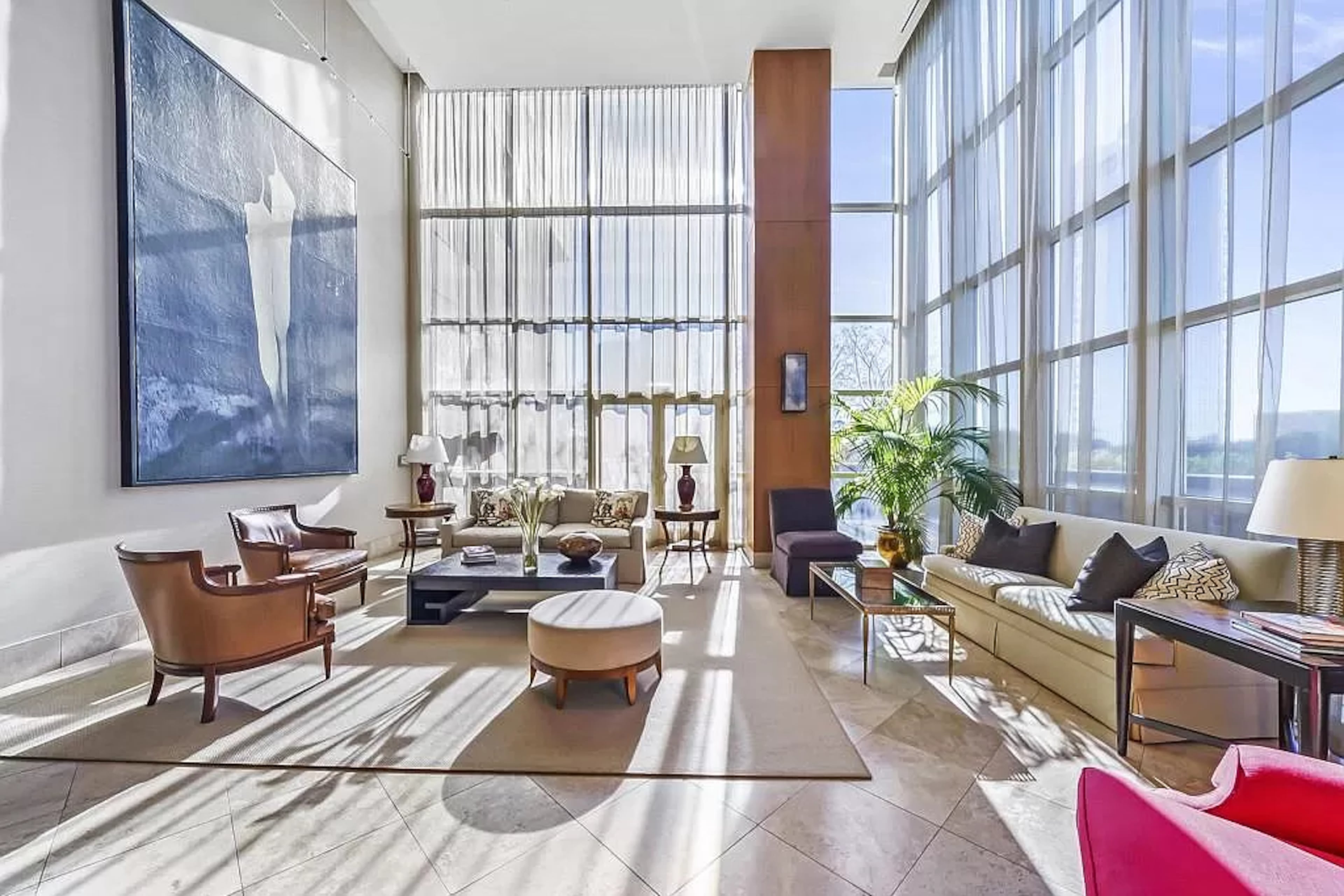 Originally a three-bedroom residence, the third bedroom was integrated into the primary suite making it a spacious sanctuary with a den and a bedroom outfitted with a wall of built-ins and a sunny sitting area.