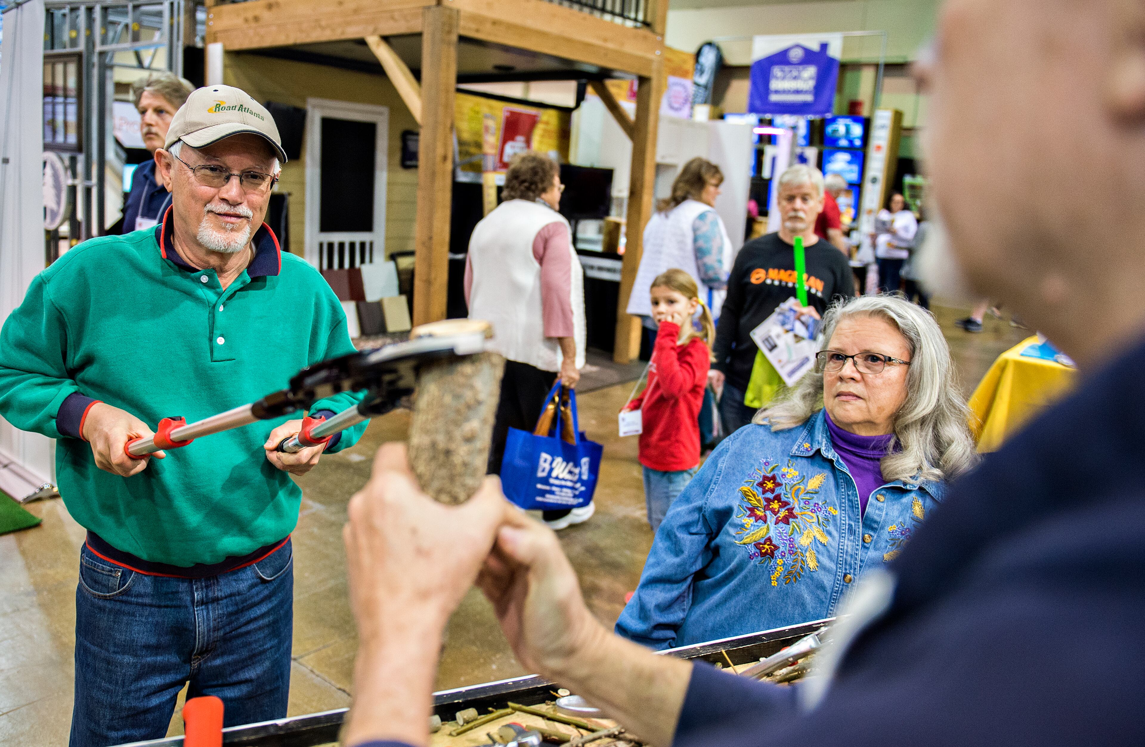 Rick January (left) learns to use a ratchet lopper as his wife, Stella, watches during the North Atlanta Home Show at the Infinite Energy Center in Duluth on Saturday, Feb. 20, 2016. JONATHAN PHILLIPS / SPECIAL