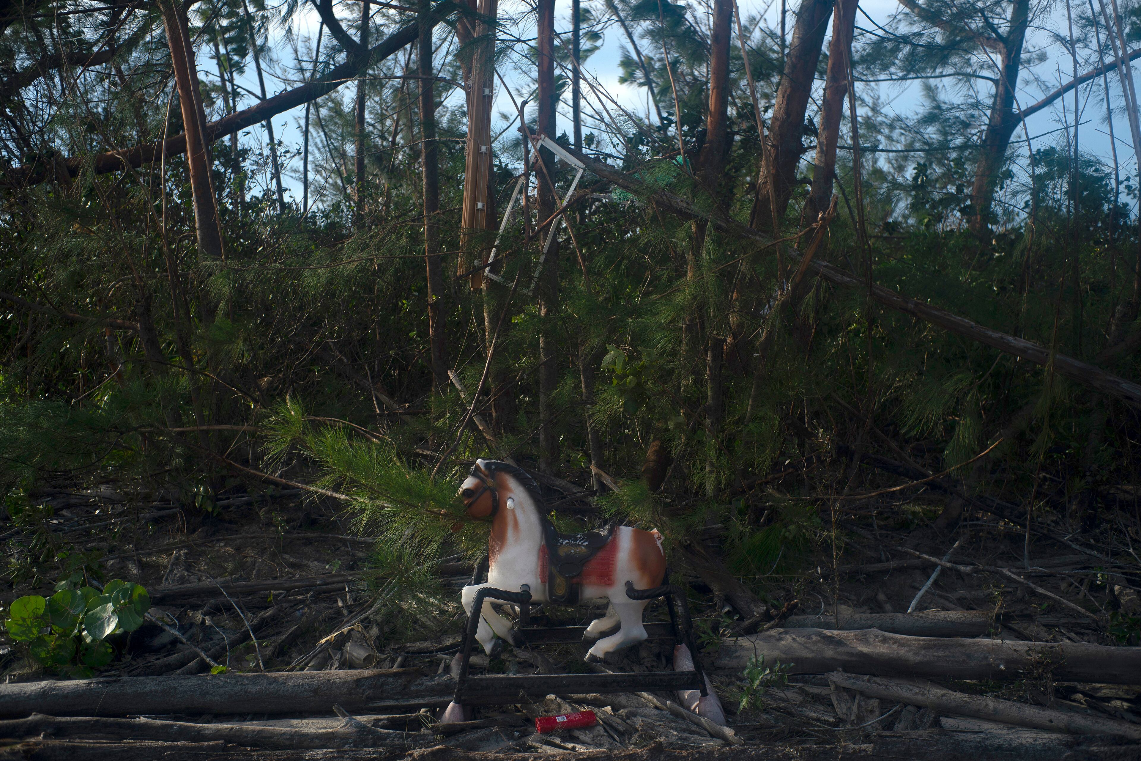 A spring rocking horse sits near a home destroyed by Hurricane Dorian, in Pine Bay, near Freeport, Bahamas, Wednesday, Sept. 4, 2019. Rescuers trying to reach drenched and stunned victims in the Bahamas fanned out across a blasted landscape of smashed and flooded homes Wednesday, while disaster relief organizations rushed to bring in food and medicine. (AP Photo/Ramon Espinosa)