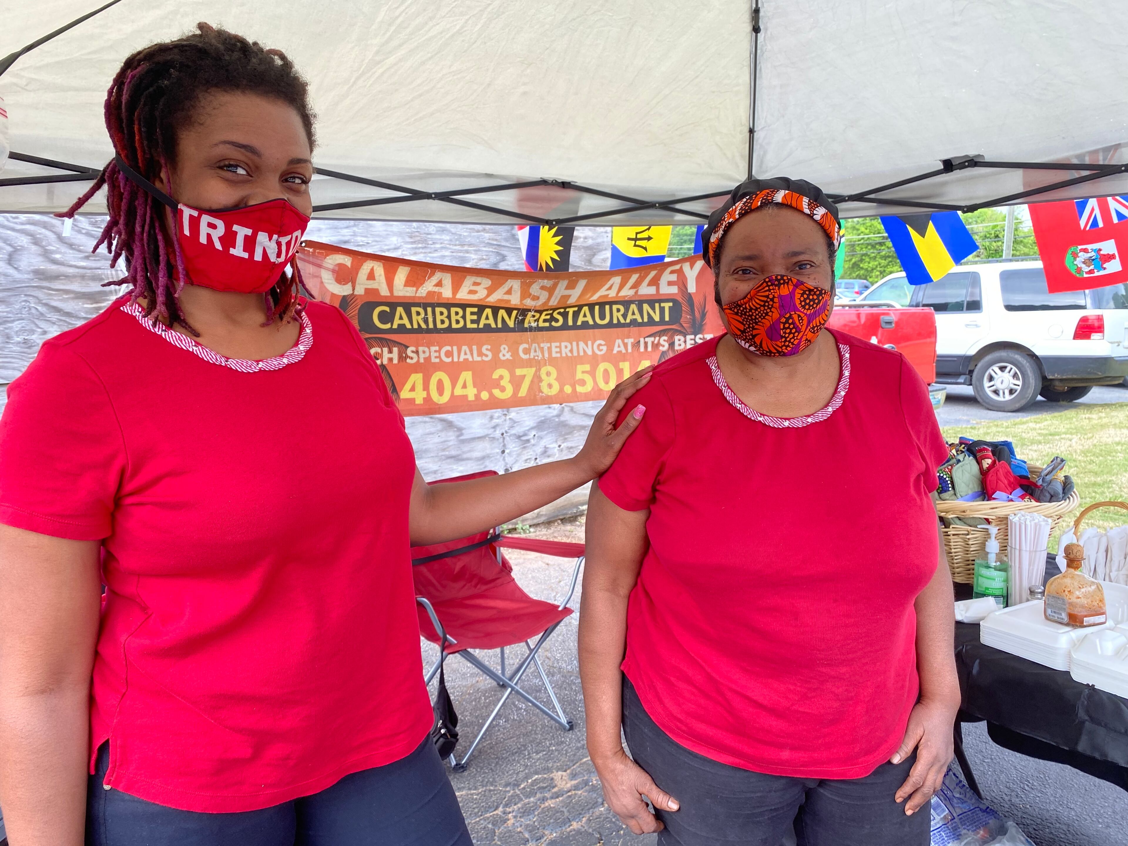 Charmaine Martin (right) and her daughter, Akilah Millar, plate up the same Caribbean fare at the Candler Black Market that they offer at their Calabash Alley restaurant in Candler Plaza. Ligaya Figueras/ligaya.figueras@ajc.com
