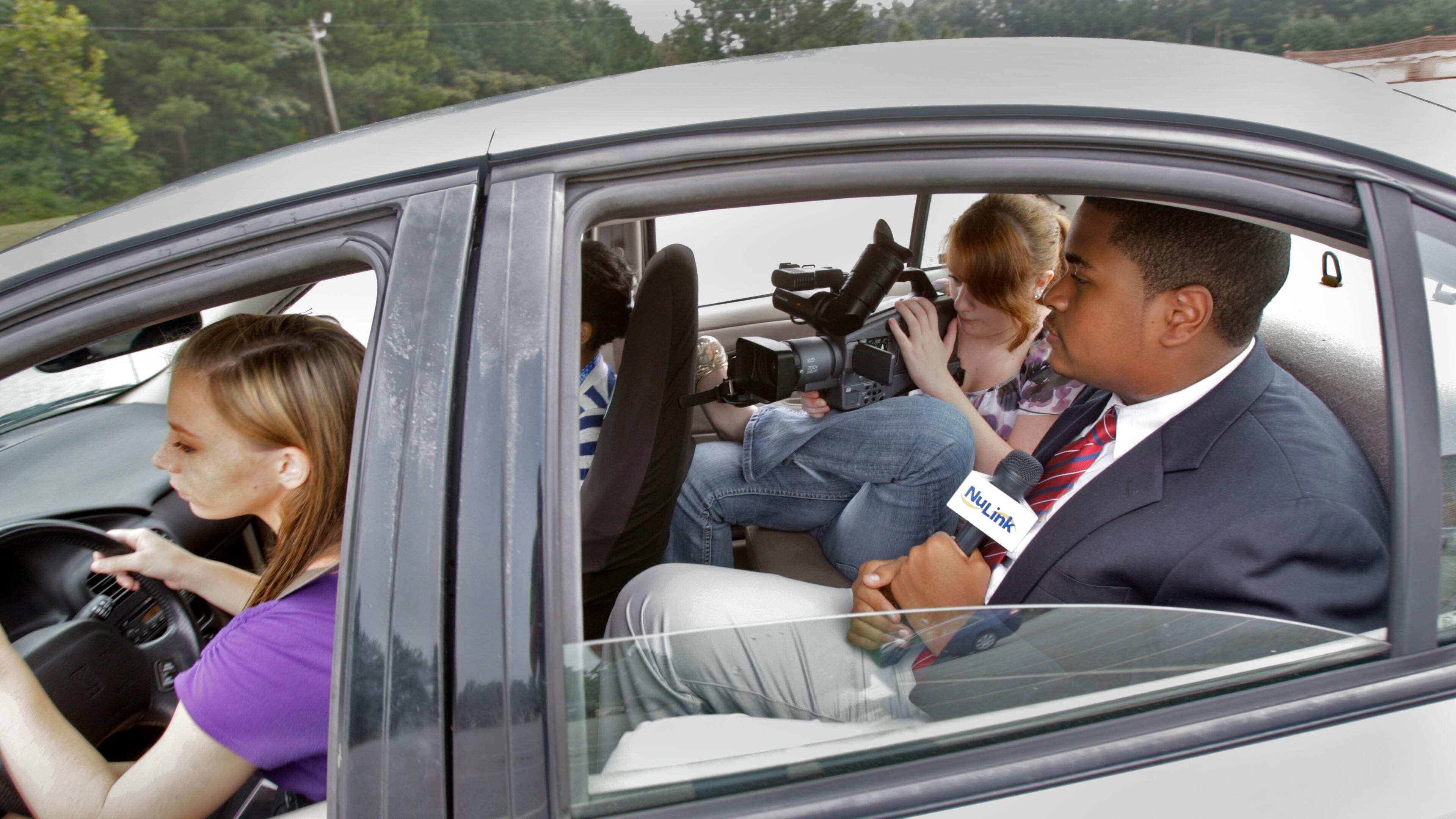 August 1, 2012 - Newnan - Amber Rogers (left) takes the wheel as Leah Gaillot and Caleb Britt film their segment on texting and driving. Students at Central Education Center, a public charter school in Cowetta County, help produce "The Link", a local cable television program. CEC has received national acclaim for its efforts in preparing students for work after high school. The students also produced their own segment on for the show on the dangers of texting and driving. BOB ANDRES / BANDRES@AJC.COM