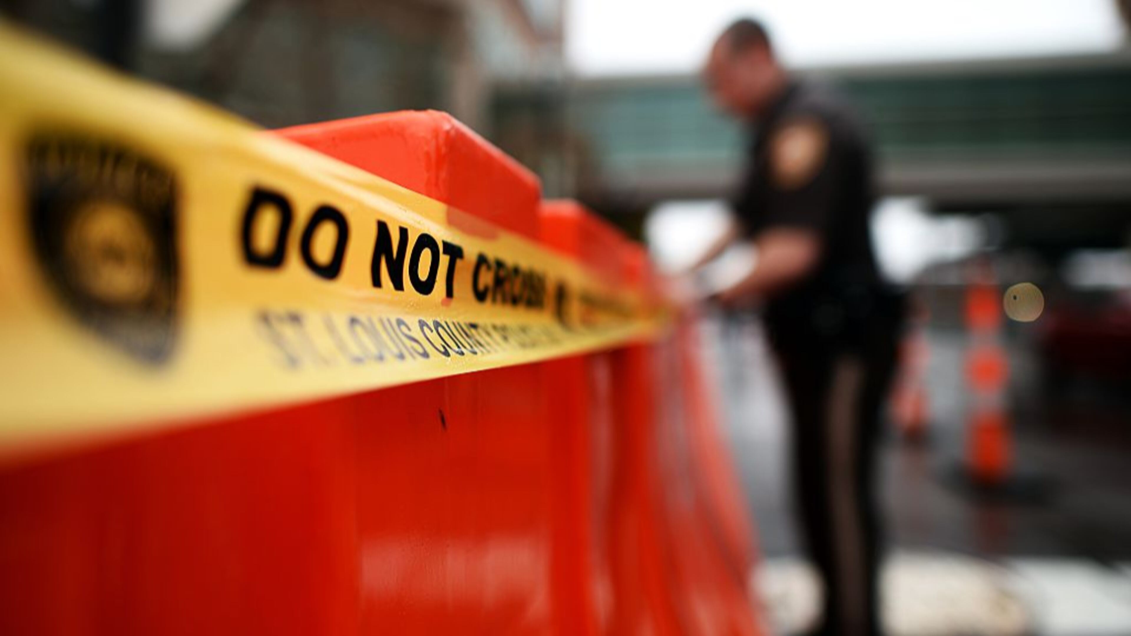 A Georgia police official stretches police tape across a road barrier. A man in DeKalb County was just sentenced to life in prison for killing his new girlfriend in the middle of a busy intersection and leaving her for dead.