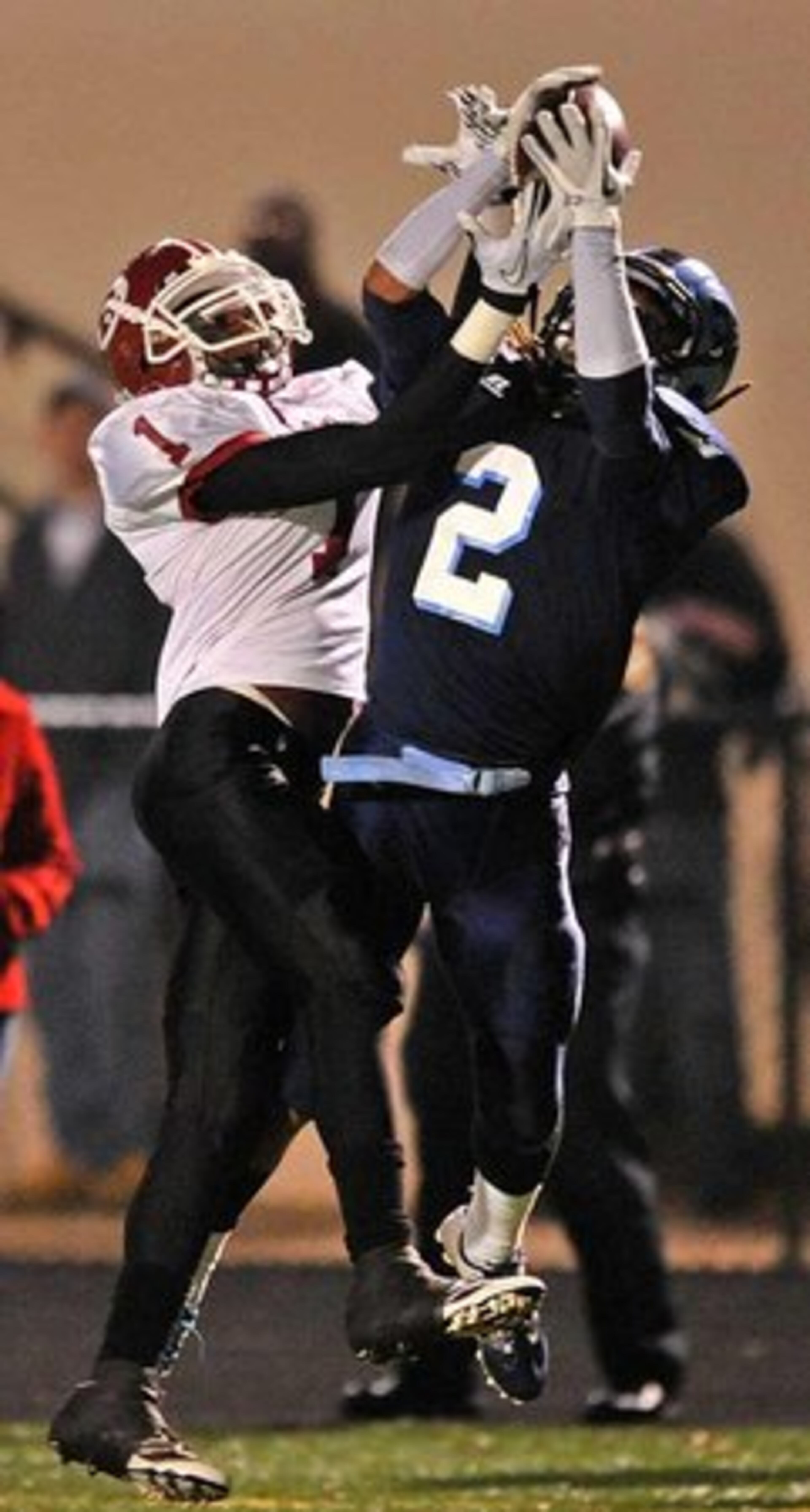 Lovejoy's Jermaine Hough (2) intercepts a pass as Warner Robins' Jalen Rountree (1) can't make the catch.