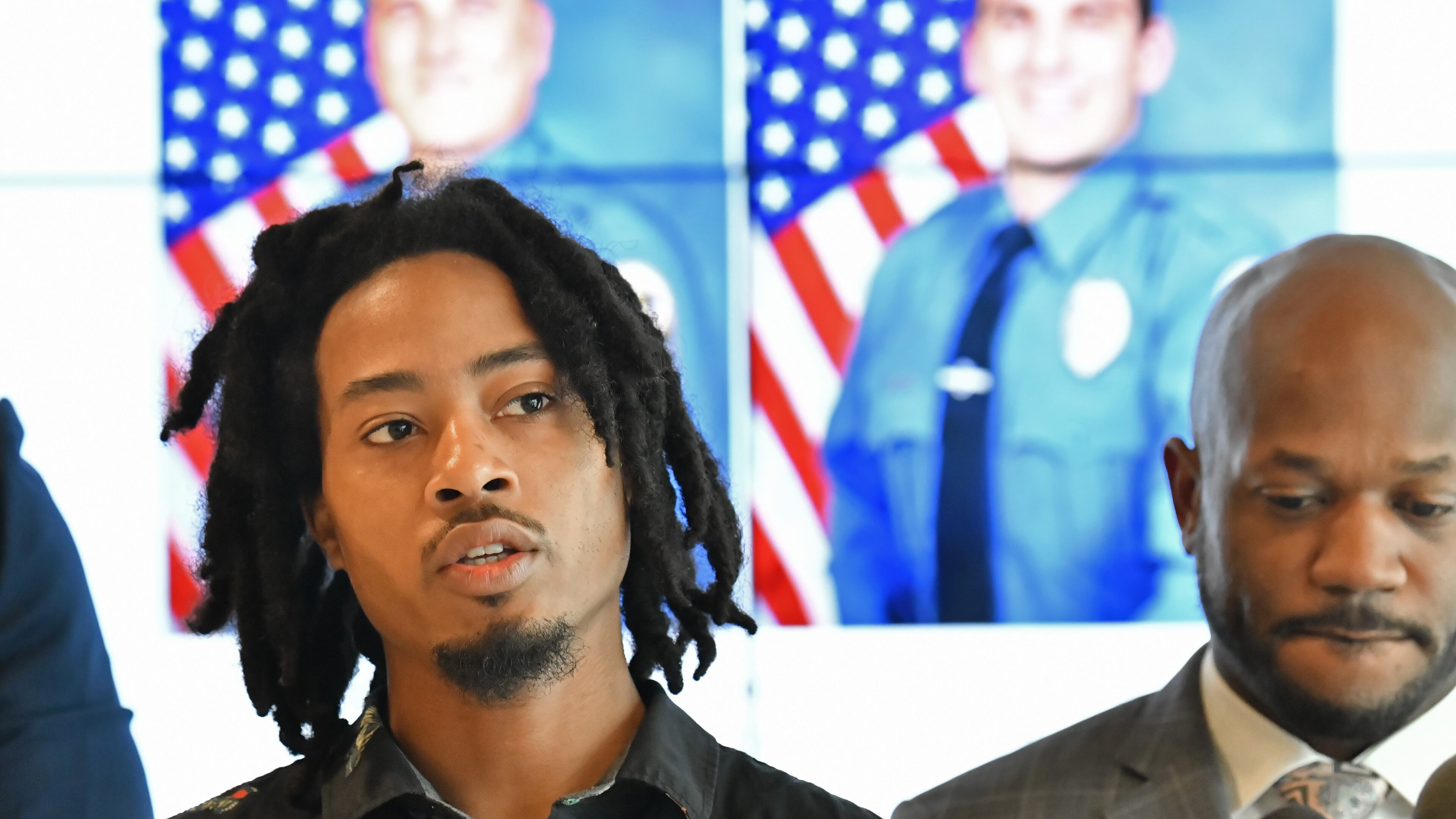 Demetrius Hollins speaks to members of the press at Stewart Miller Simmons Trial Attorneys Offices in September 2021 in Atlanta. Hollins, who was beaten and kicked by Gwinnett County officers, has reached a $400,000 settlement in his federal lawsuit, according to the county. (Hyosub Shin / Hyosub.Shin@ajc.com)