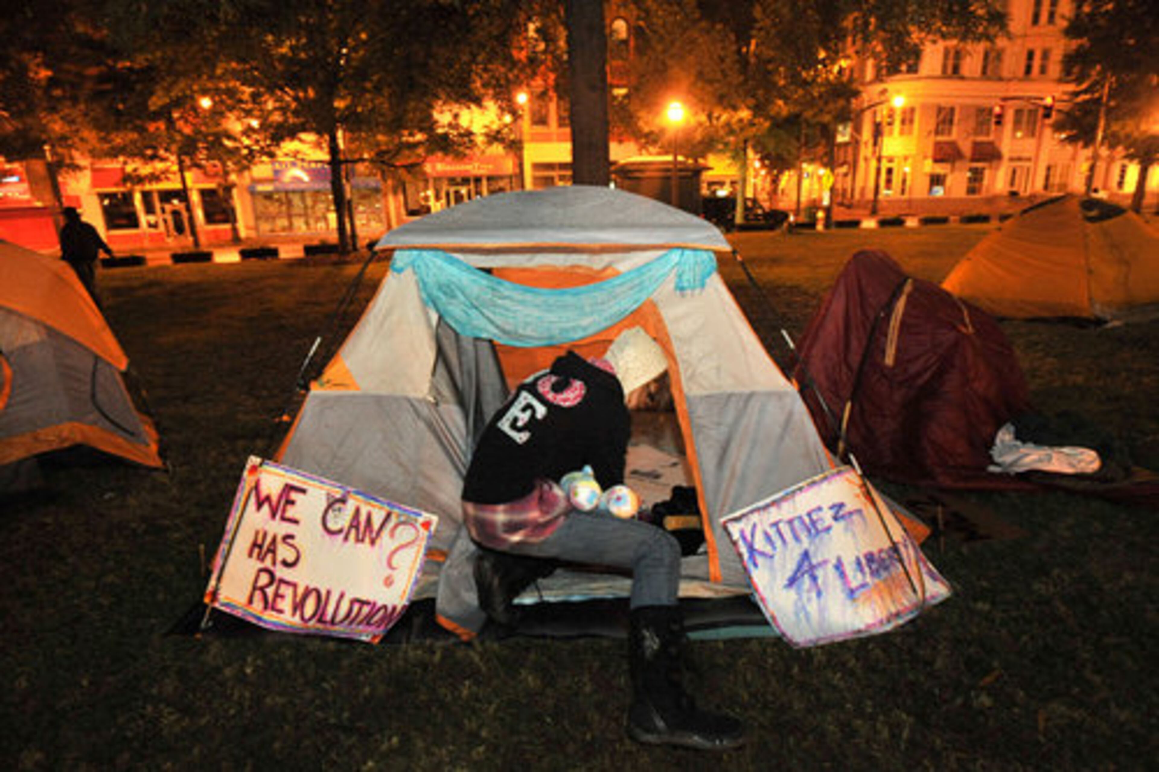 Kimlee Davis, who is a freshmen at Georgia State University, moves her belongings to another tent where she planned to stay overnight Thursday.