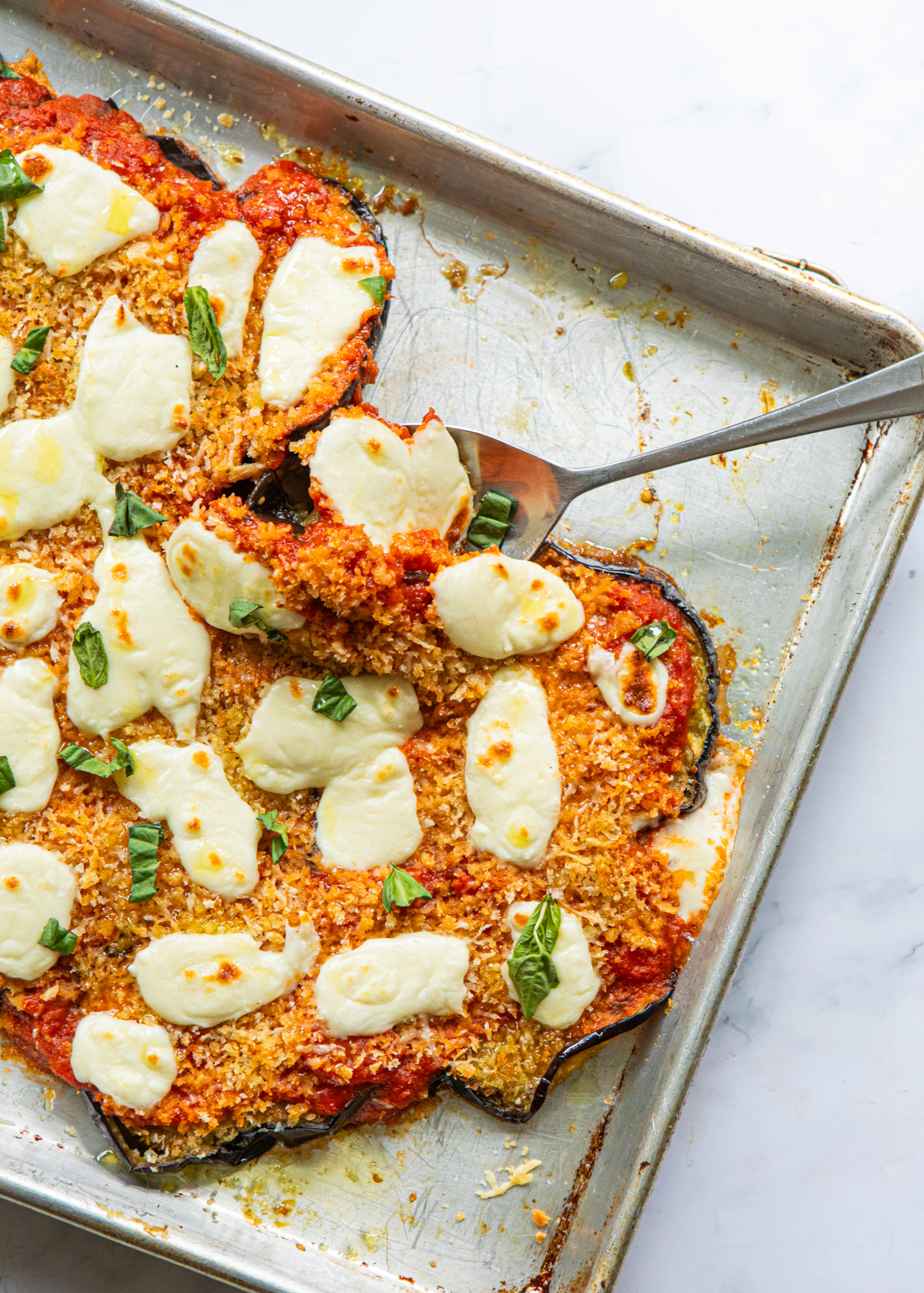 The best order for assembling eggplant Parmesan on a sheet pan is a little different from a traditional recipe. (Aaliyah Man for the AJC/food styled by Kate Williams)