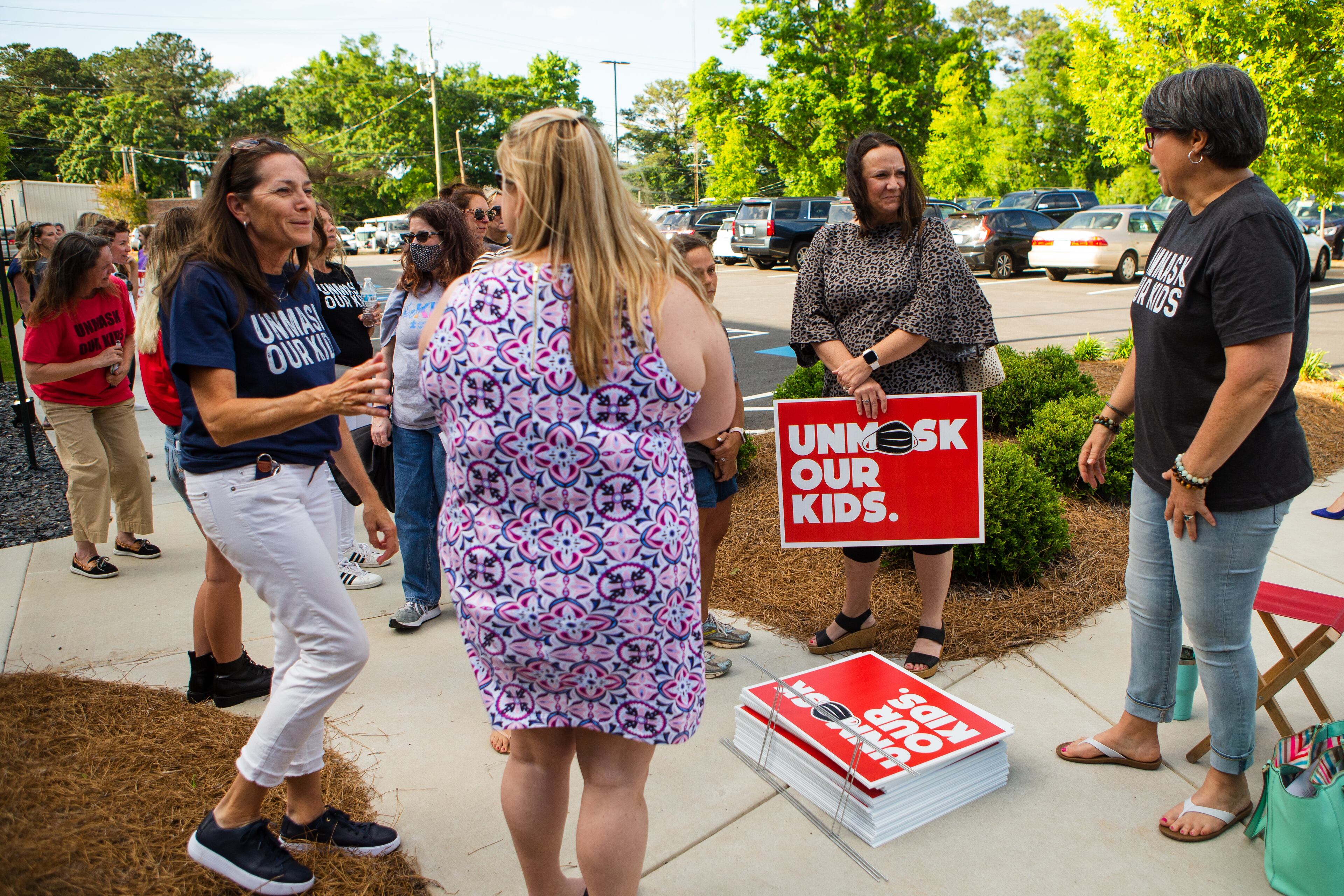 Cobb County community members gather outside of the school district office in Marietta, Georgia, on May 20, 2021, to show their opposition to students wearing masks. Many community members waited in line to speak at the school board meeting to voice their support for unmasking. (CHRISTINA MATACOTTA FOR THE ATLANTA JOURNAL-CONSTITUTION)
