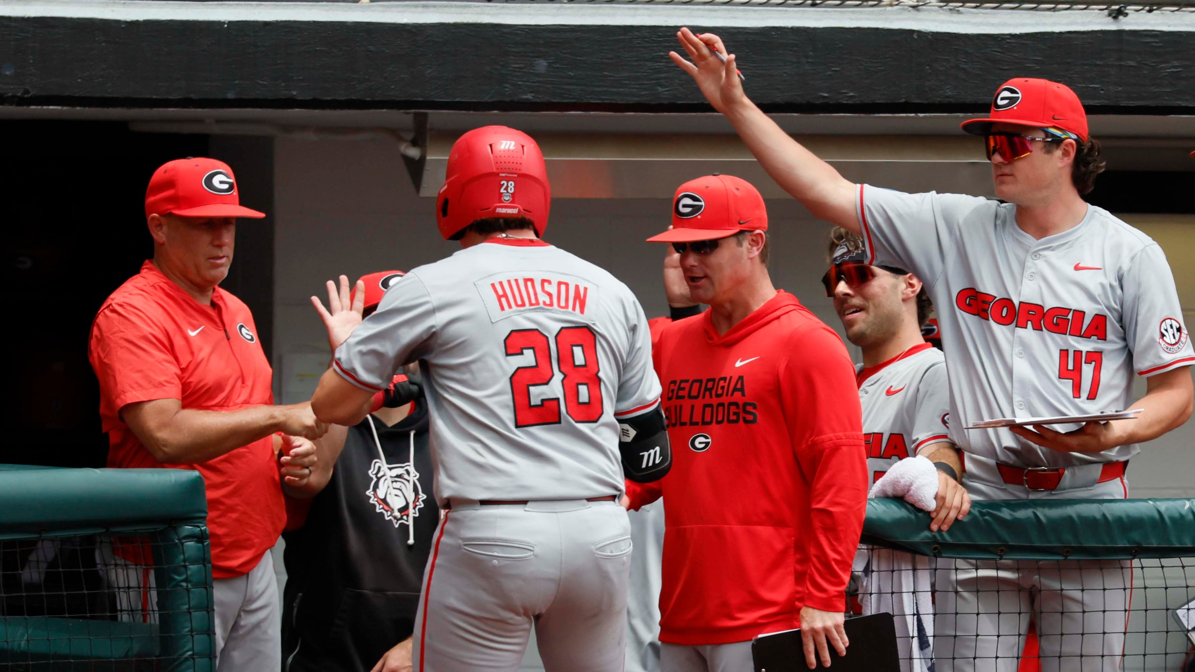 Georgia head coach Wes Johnson (left) gives a fist pump to catcher Brennan Hudson (28) after his solo home run during the third inning of Game 2 of their NCAA Super Regional at Foley Field on Sunday, June 7, 2026, in Athens. (Miguel Martinez/AJC)
