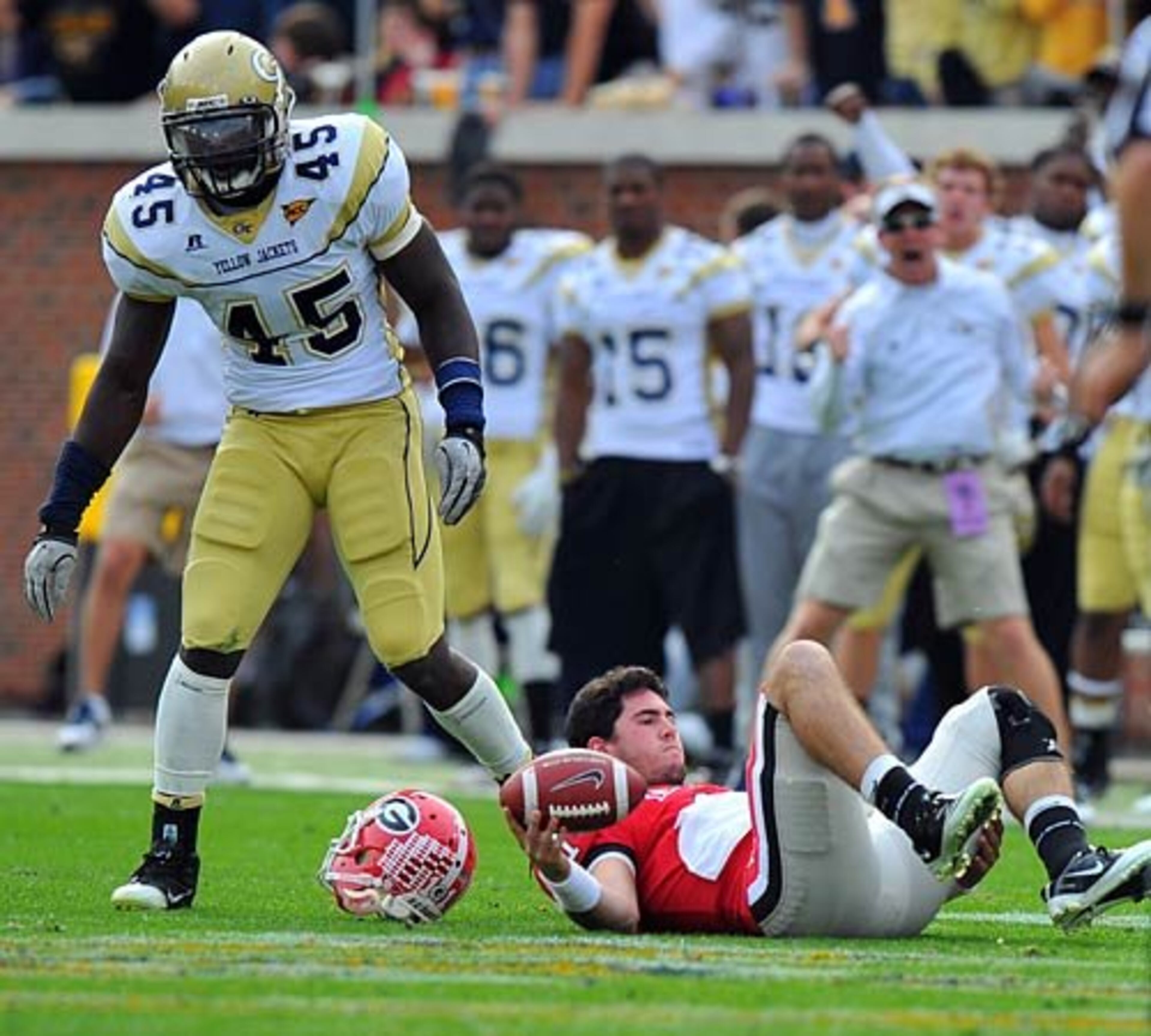 Georgia quarterback Aaron Murray has his helmet knocked off by Georgia Tech's Jeremiah Attaochu during the second half of play.
