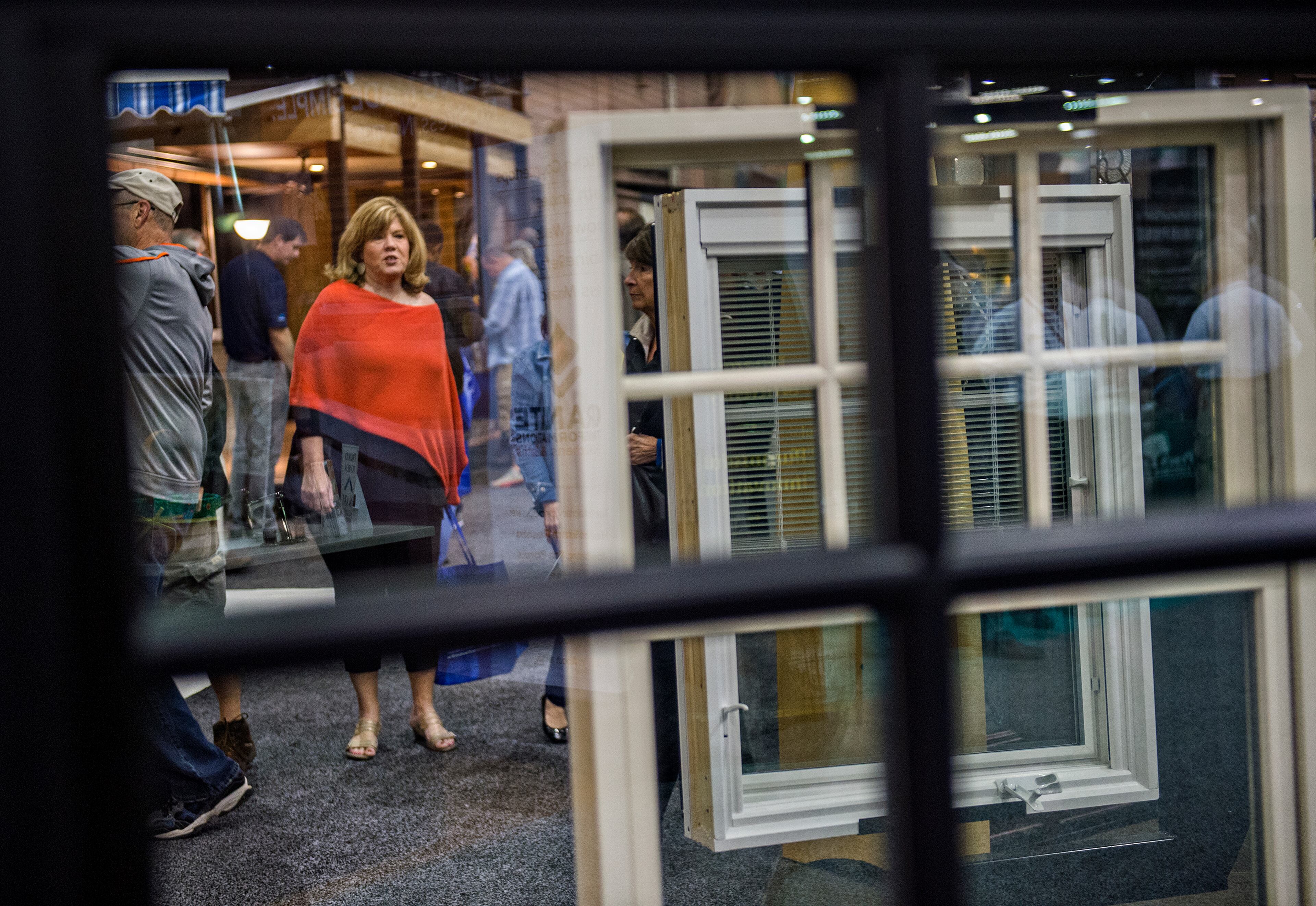 Grace Fry (left) passes by window displays during the 37th annual Spring Atlanta Home Show at the Cobb Galleria Centre in Atlanta on Sunday, March 22, 2015. The three day show featured exhibits and seminars on landscaping and lawn care, kitchen appliances, fixtures, flooring, roofing, siding, concrete, windows, heating and air conditioning, patios and insulation. JONATHAN PHILLIPS / SPECIAL