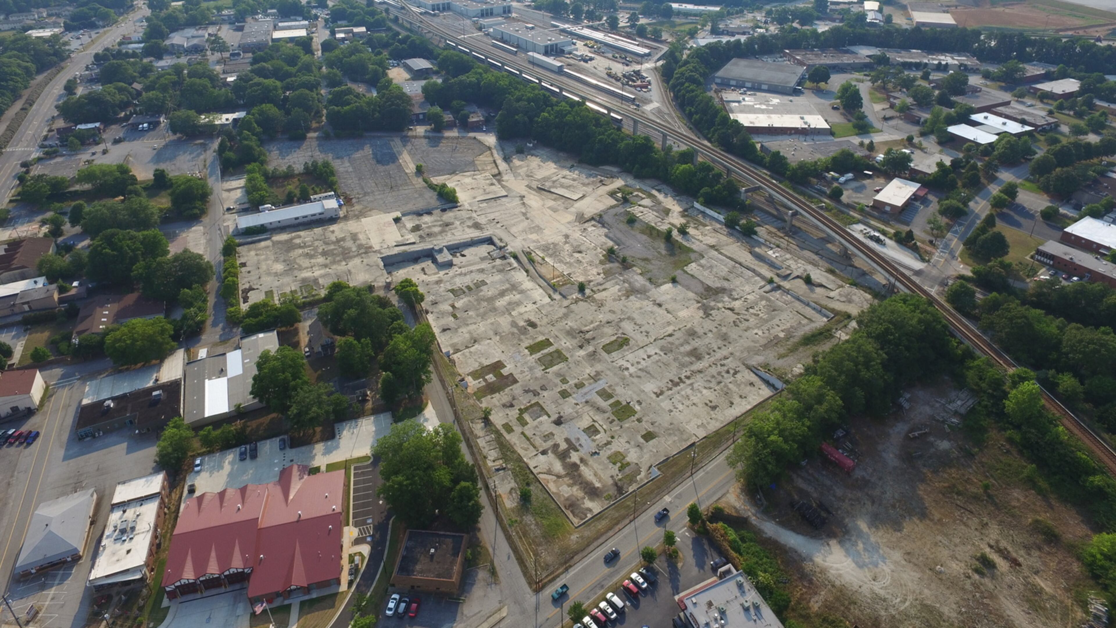 The 13 acres owned by Avila Real Estate just north of downtown Avondale Estates, future home of a mixed use development that may include as many as 400 apartments. Much of the concrete shown here will be broken up and reused and resculpted for the project. The city owns four acres in this photo’s left center it wants to combine with Avila for a complimentary project. Courtesy of Avila Real Estate