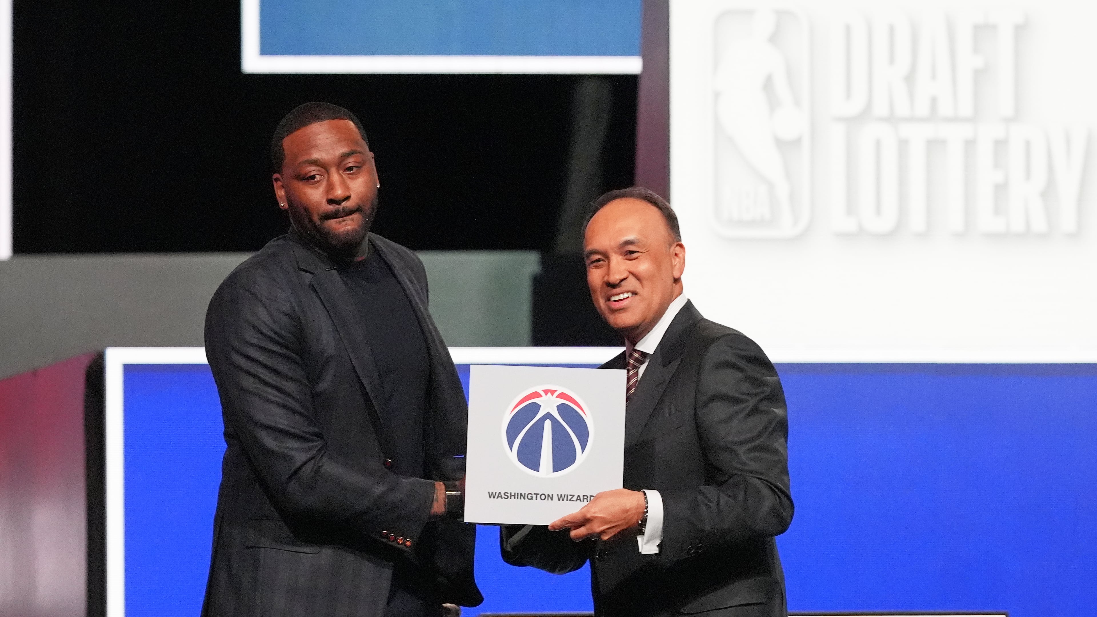 Washington Wizards' John Wall, left, and NBA Deputy Commissioner Mark Tatum, pose for photos after Tatum announced that the Wizards had won the first pick in the NBA basketball draft lottery in Chicago, Sunday, May 10, 2026. (AP Photo/Nam Y. Huh)