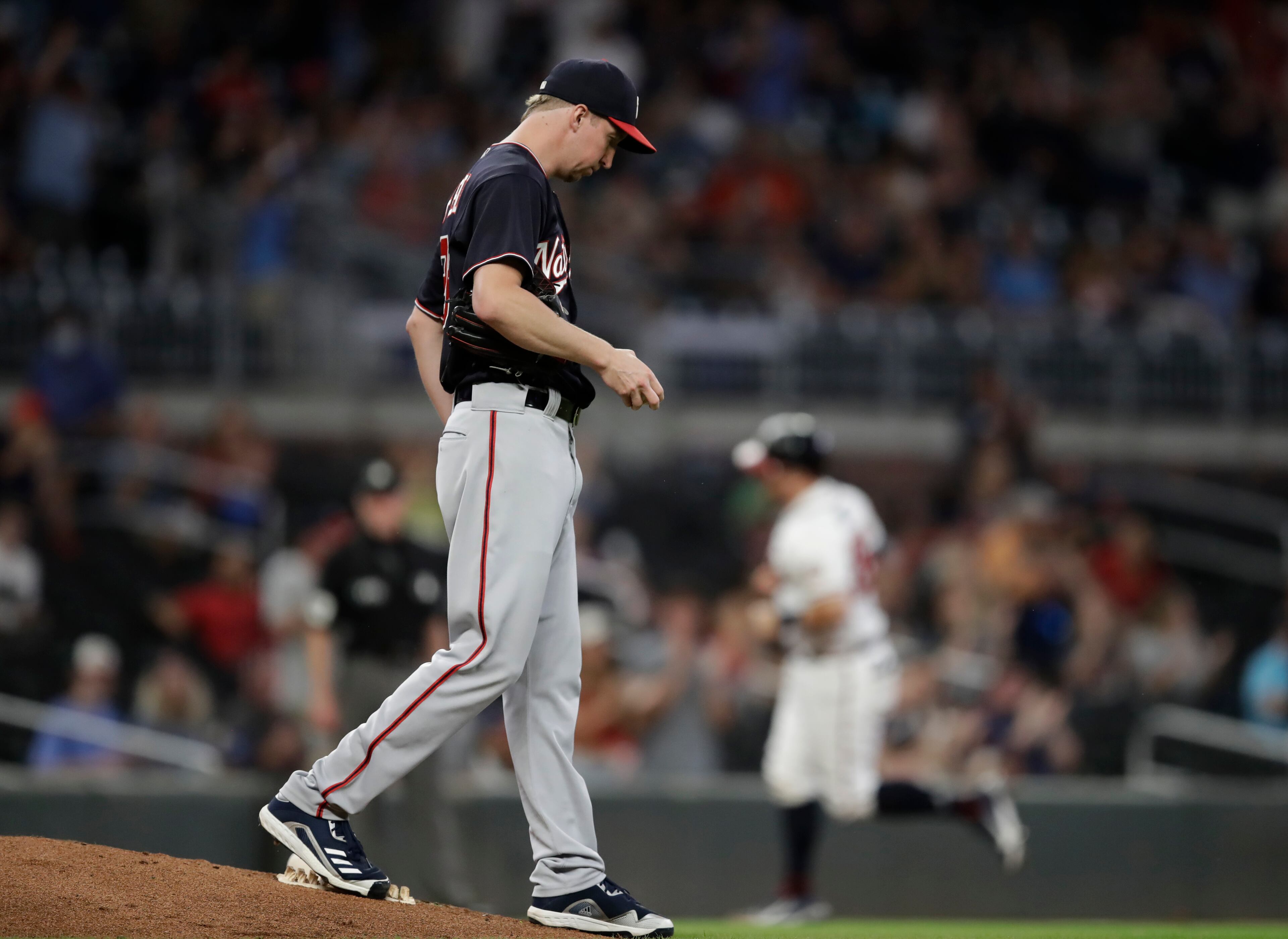 Washington Nationals pitcher Erick Fedde waits for Atlanta Braves' Stephen Vogt to run the bases on a home run during the third inning of a baseball game Thursday, Sept. 9, 2021, in Atlanta. (AP Photo/Ben Margot)
