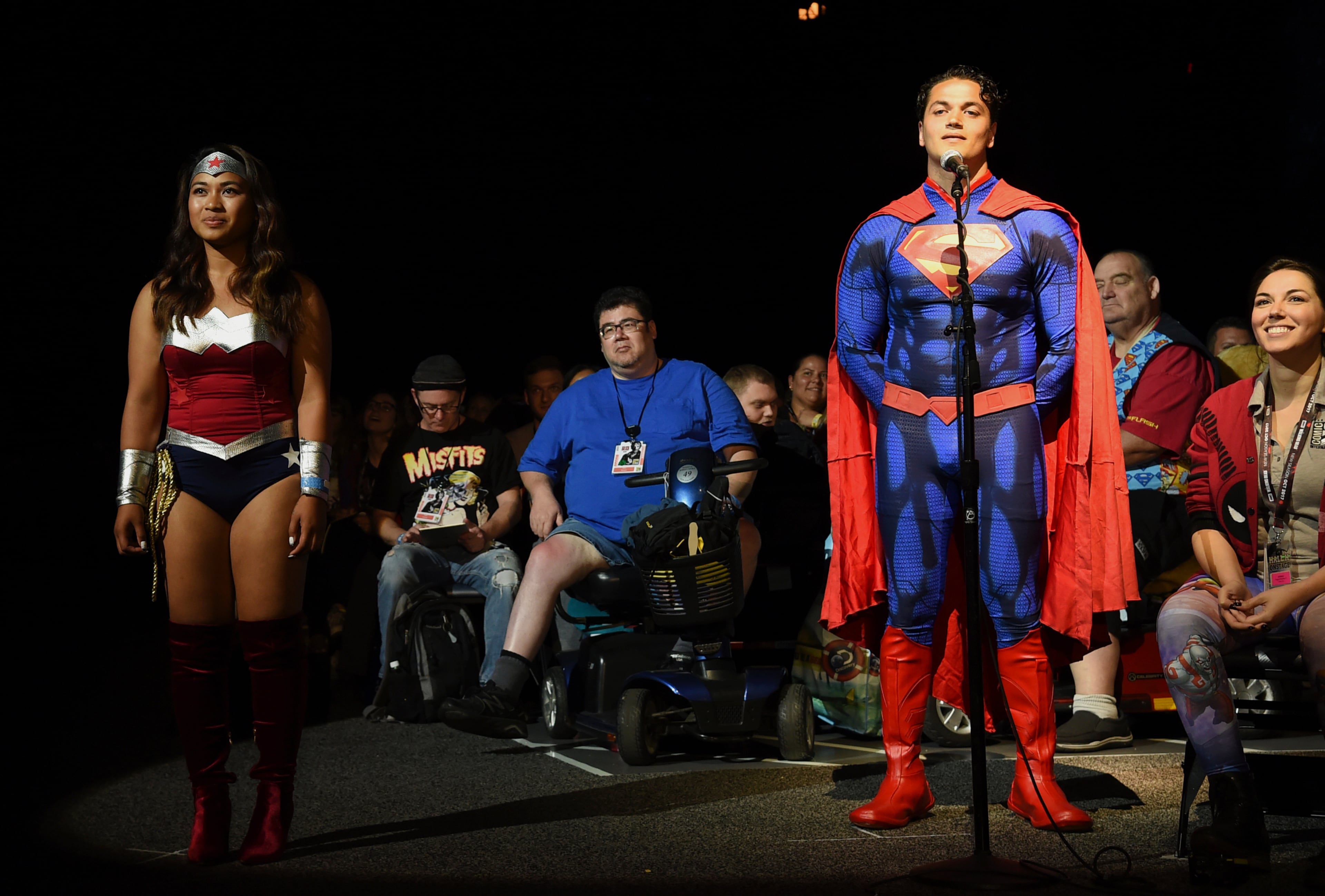 Guests dressed like Wonder Woman, left, and Superman attend the Warner Bros. Presentation panel on day three of Comic-Con International on Saturday, July 22, 2017, in San Diego. (Photo by Richard Shotwell/Invision/AP)