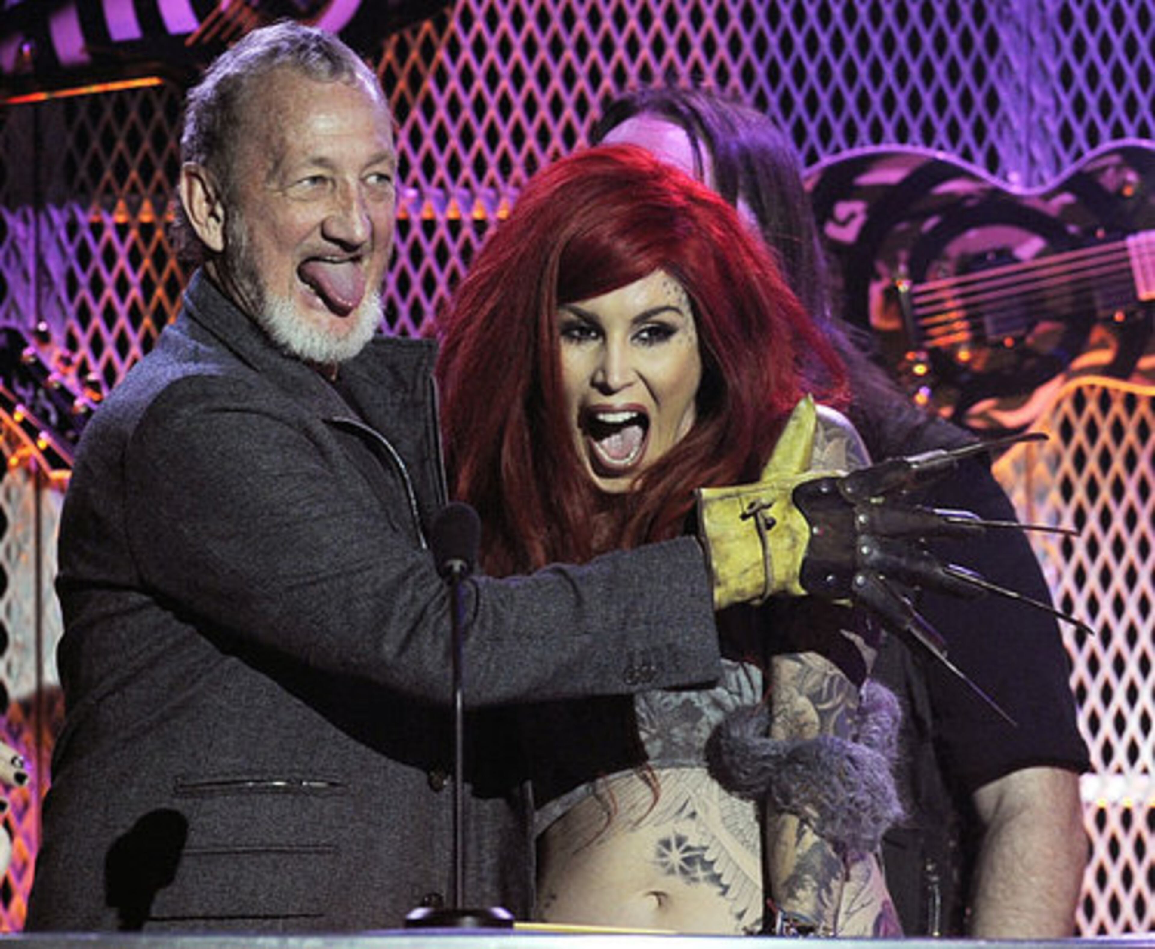 Actor Robert Englund, left, of the "Nightmare on Elm Street" horror films, accepts the Honorary Headbanger of the Year award from tattoo artist Kat Von D.