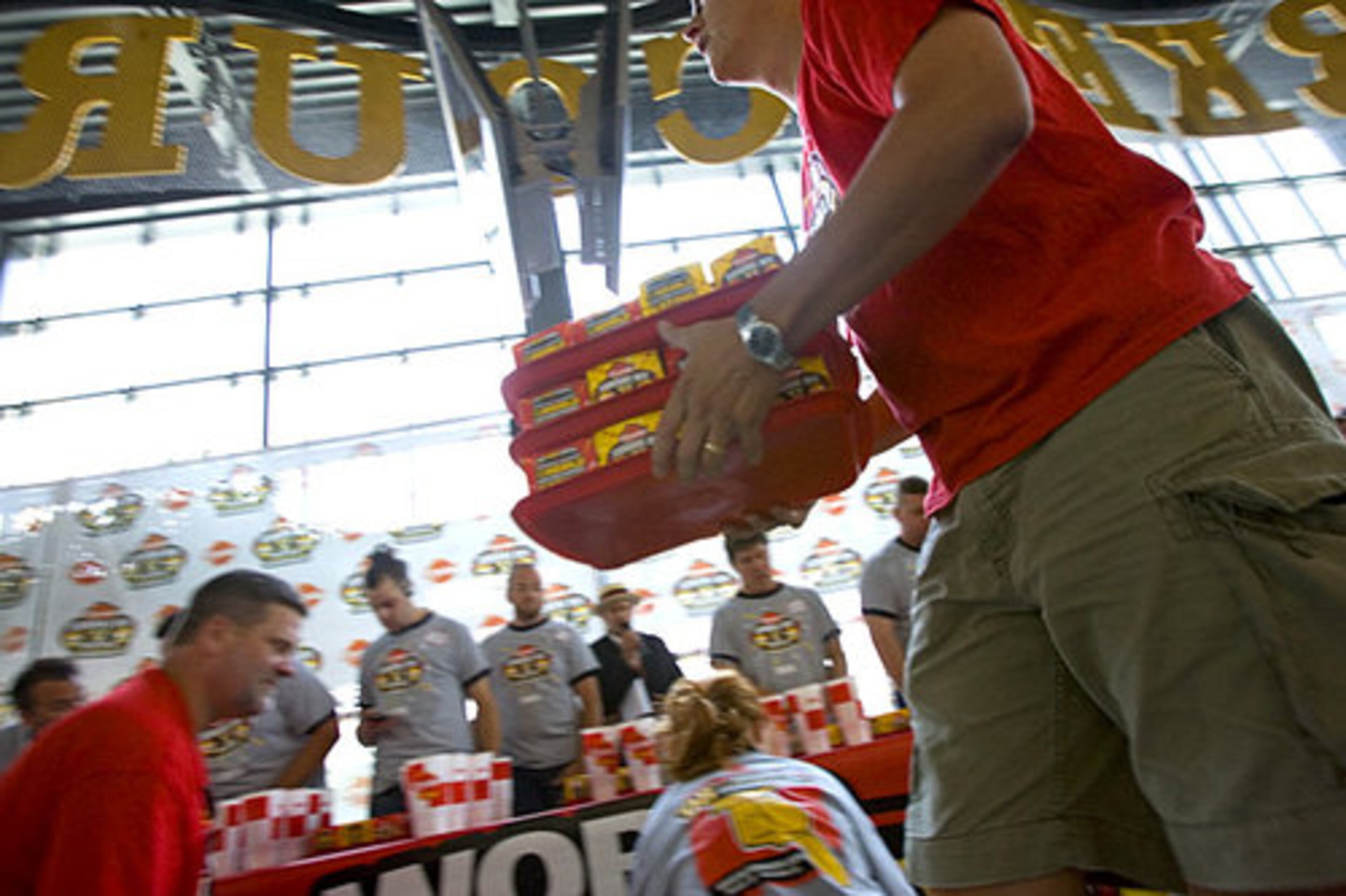 Hamburgers are brought out for the competition. The 1,000 burgers prepared for speedy consumption were without cheese and pickles -- choking hazards -- and went light on the onions and mustard.
