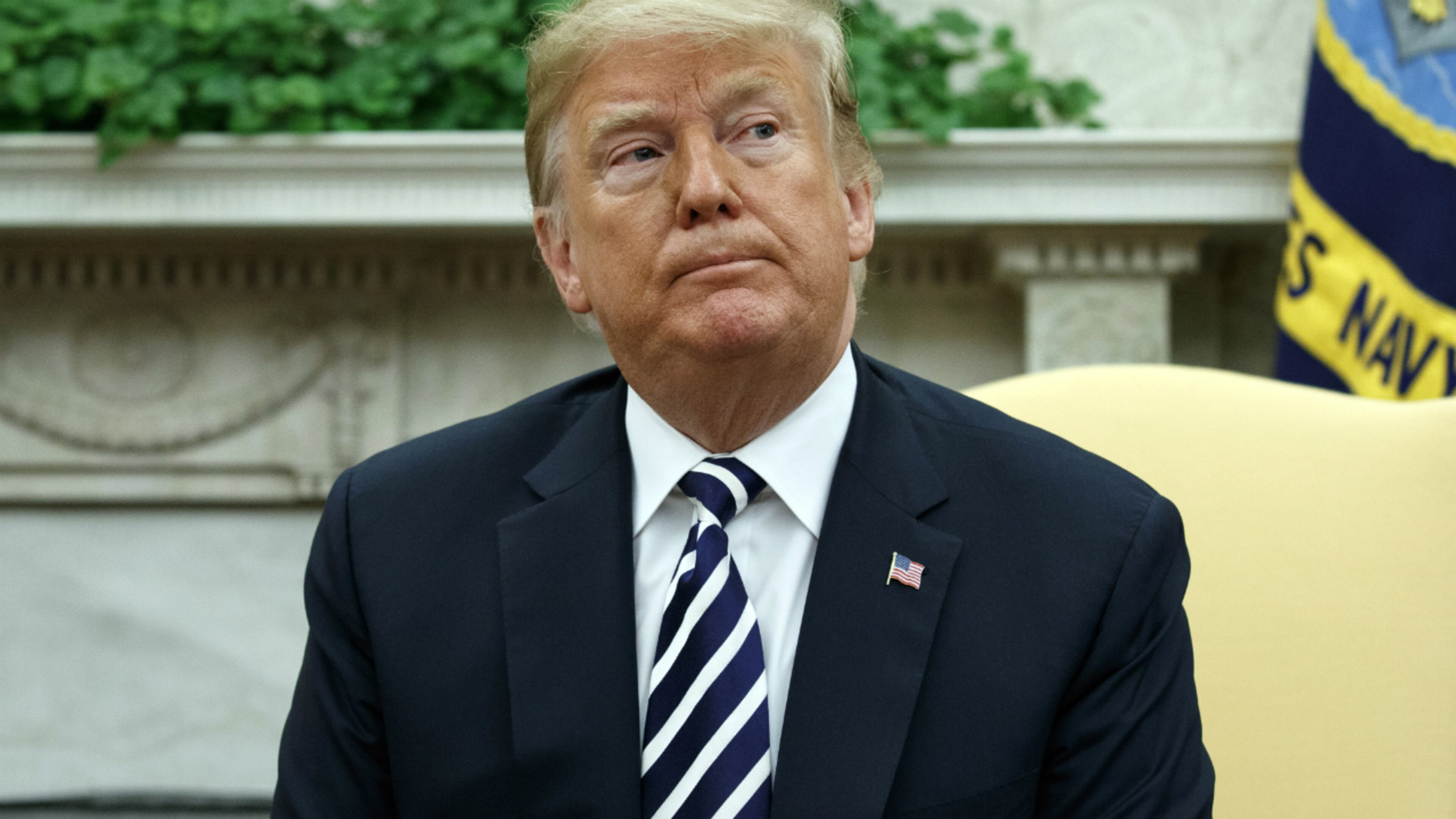 President Donald listens to a question from a reporter during a meeting with Polish President Andrzej Duda in the Oval Office of the White House, Tuesday, Sept. 18, 2018, in Washington.