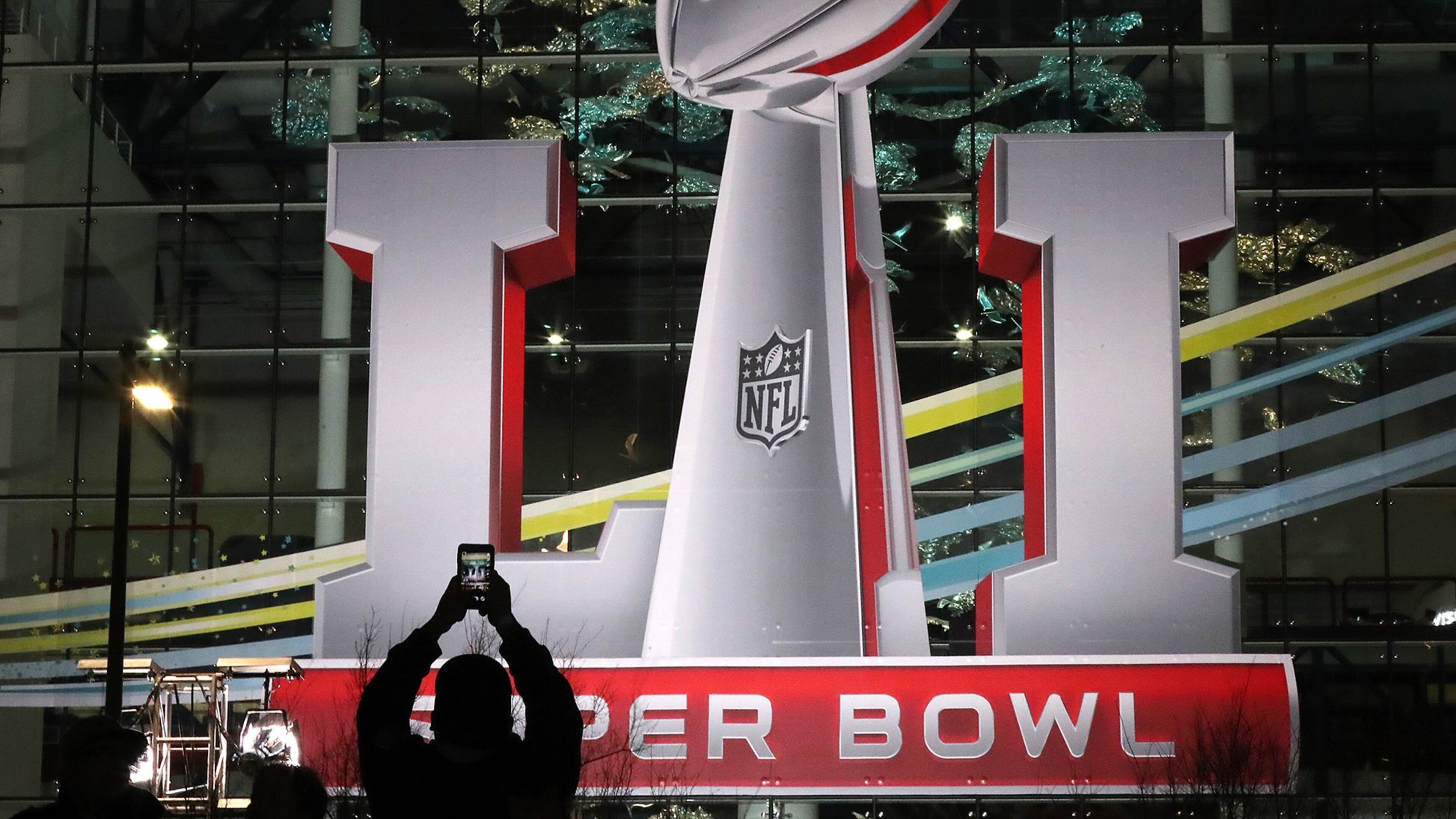 February 2, 2017, Houston: A football fan snaps a photo of the Super Bowl logo during the NFL Experience at George R. Brown Convention Center from his vantage point in Discovery Green park on Thursday night, Feb. 2, 2017, in Houston. Curtis Compton/ccompton@ajc.com