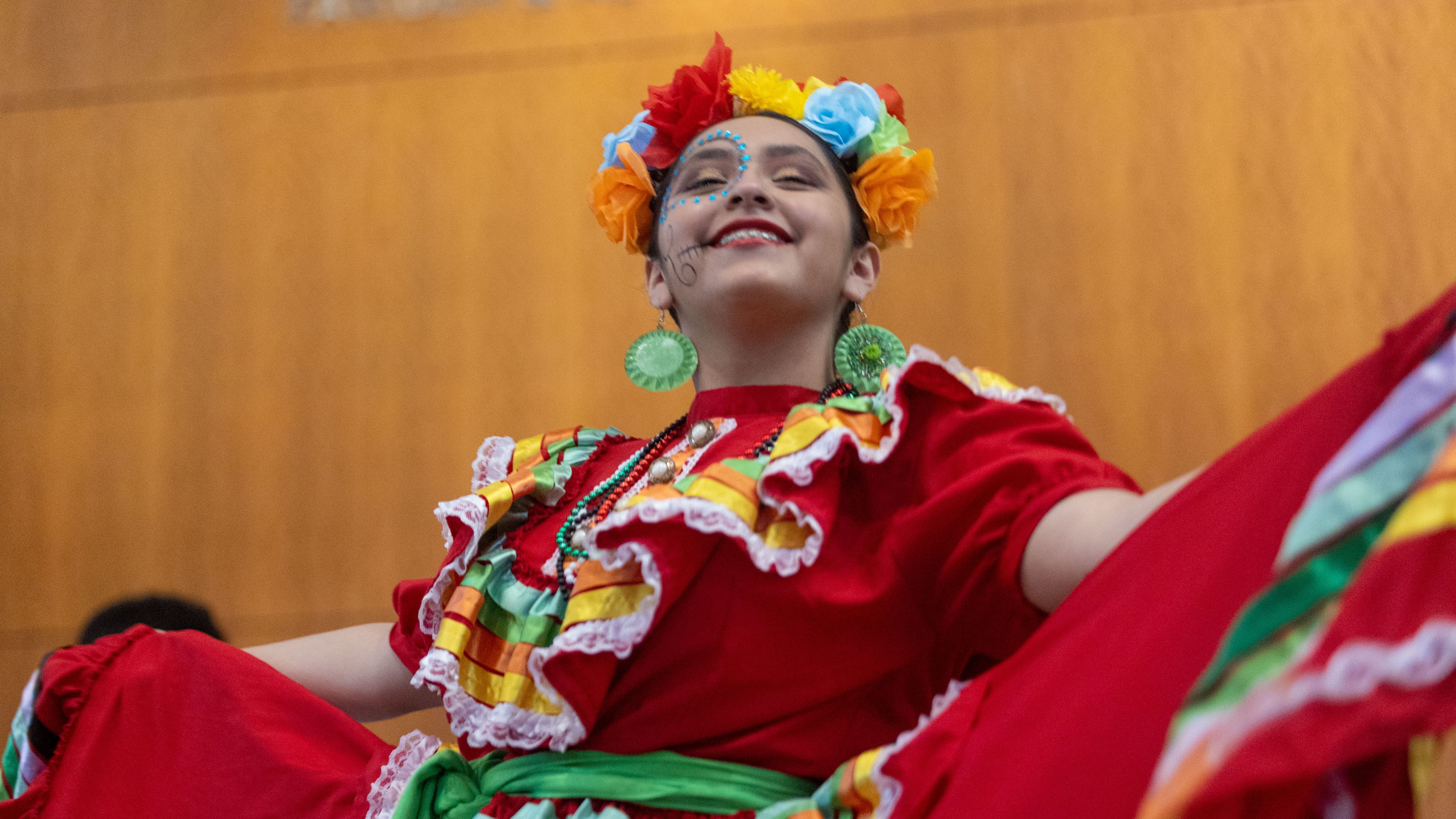 A girl performs a dance at the Atlanta Symphony Orchestra's Dia de Los Muertos Festival at the Woodruff Arts Center in 2022. (Jenn Finch for the AJC)
