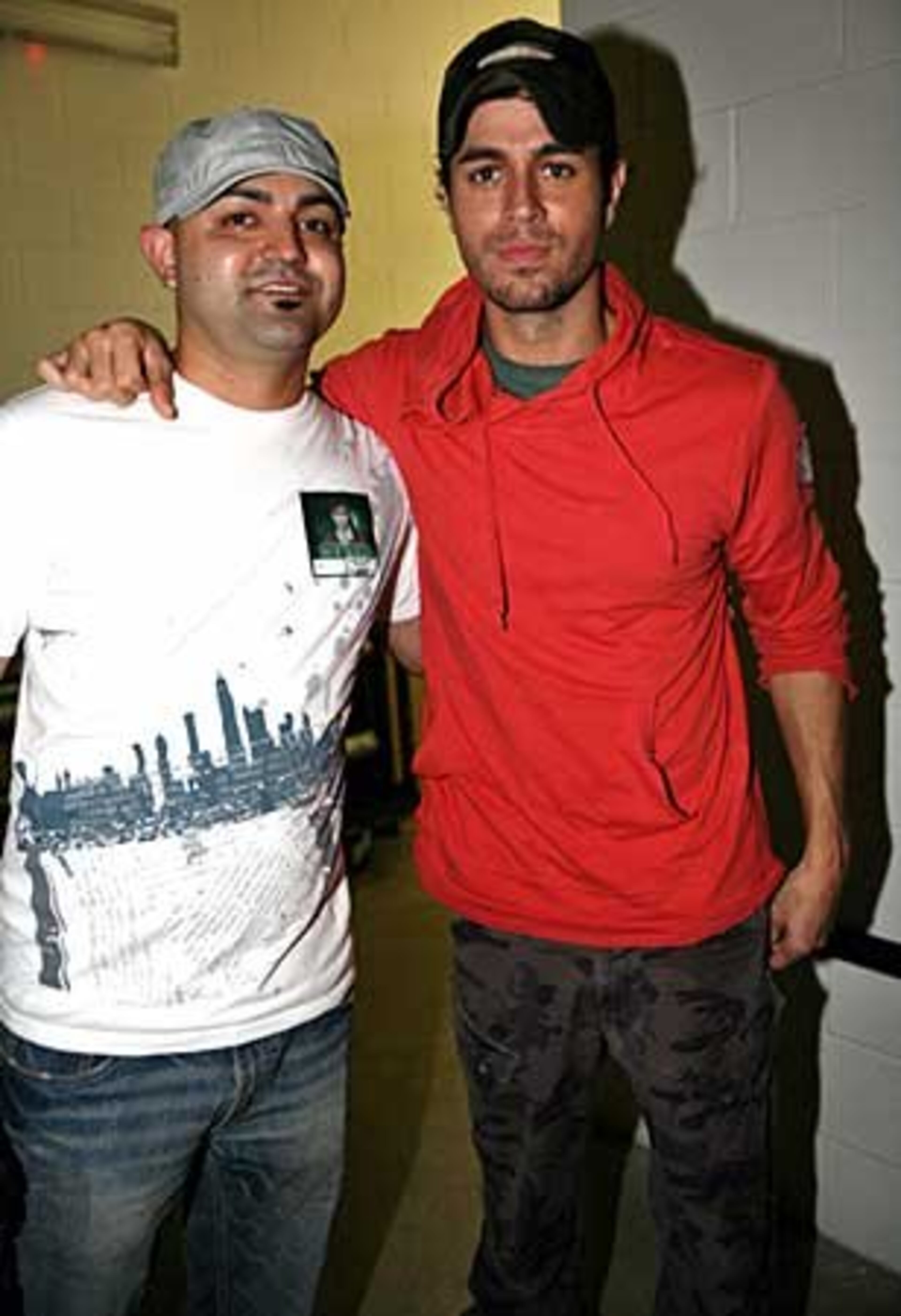 Enrique Iglesias poses backstage with SamTerrazas, promotions director at Viva 105.7 FM.