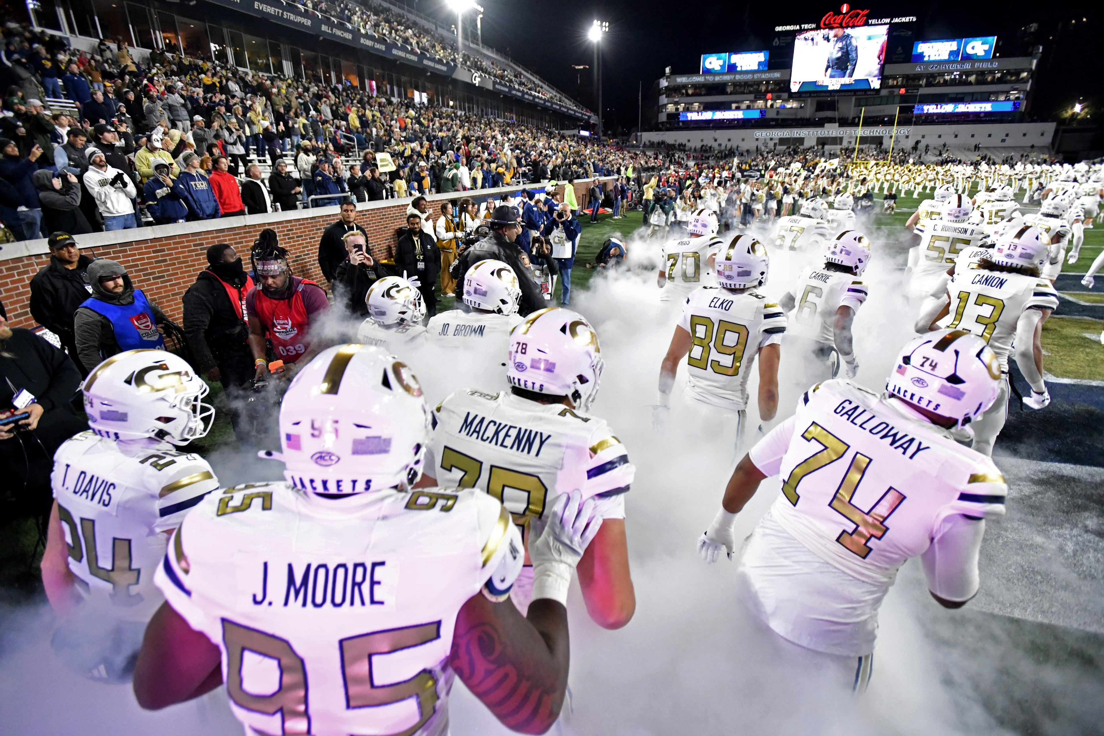 Georgia Tech players run onto the football field before an NCAA college between Georgia Tech and North Carolina State at Bobby Dodd Stadium, Thursday, November 21, 2024, in Atlanta. (Hyosub Shin / AJC)