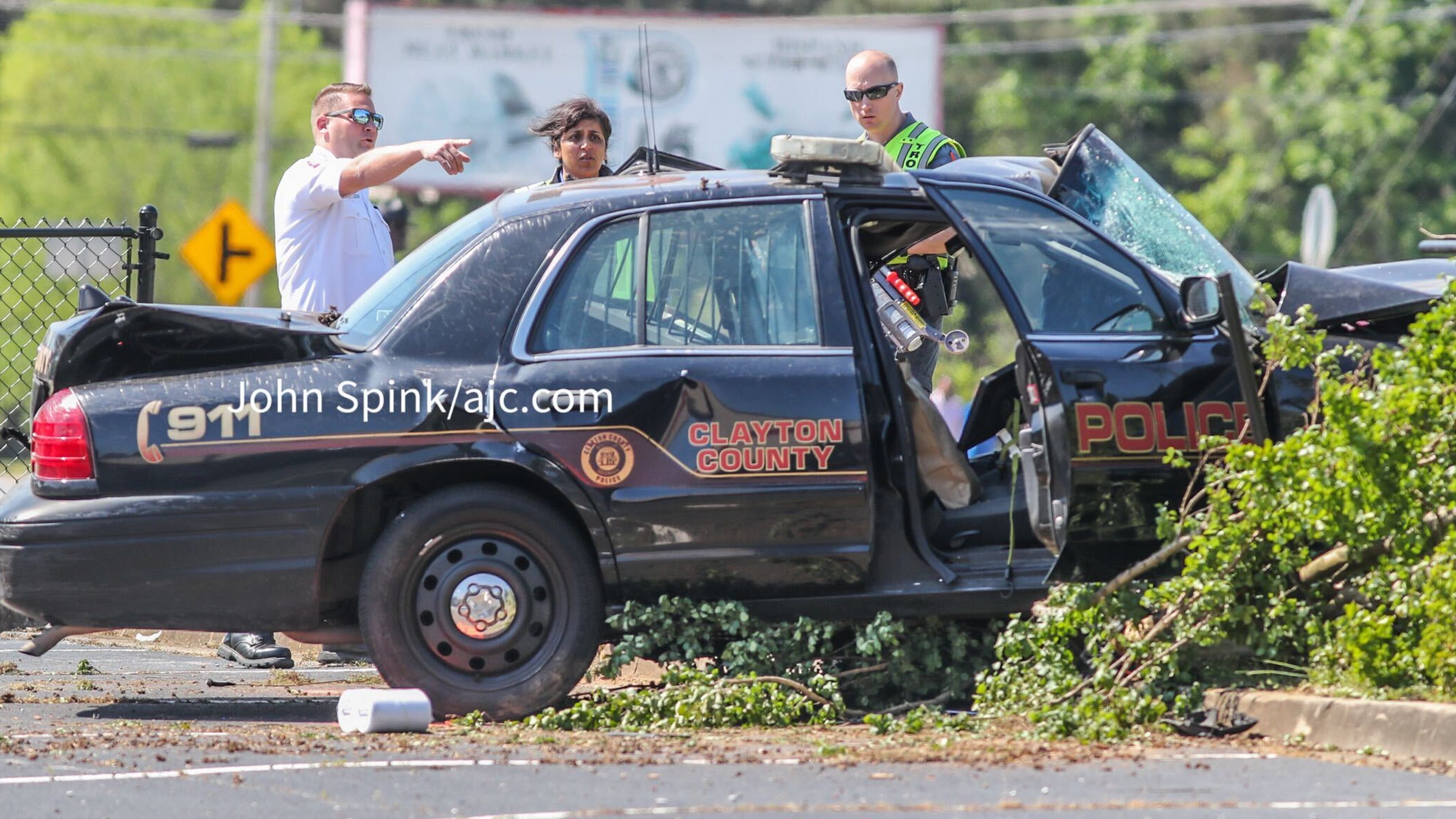 The officer's damaged patrol car ended up in a parking lot.