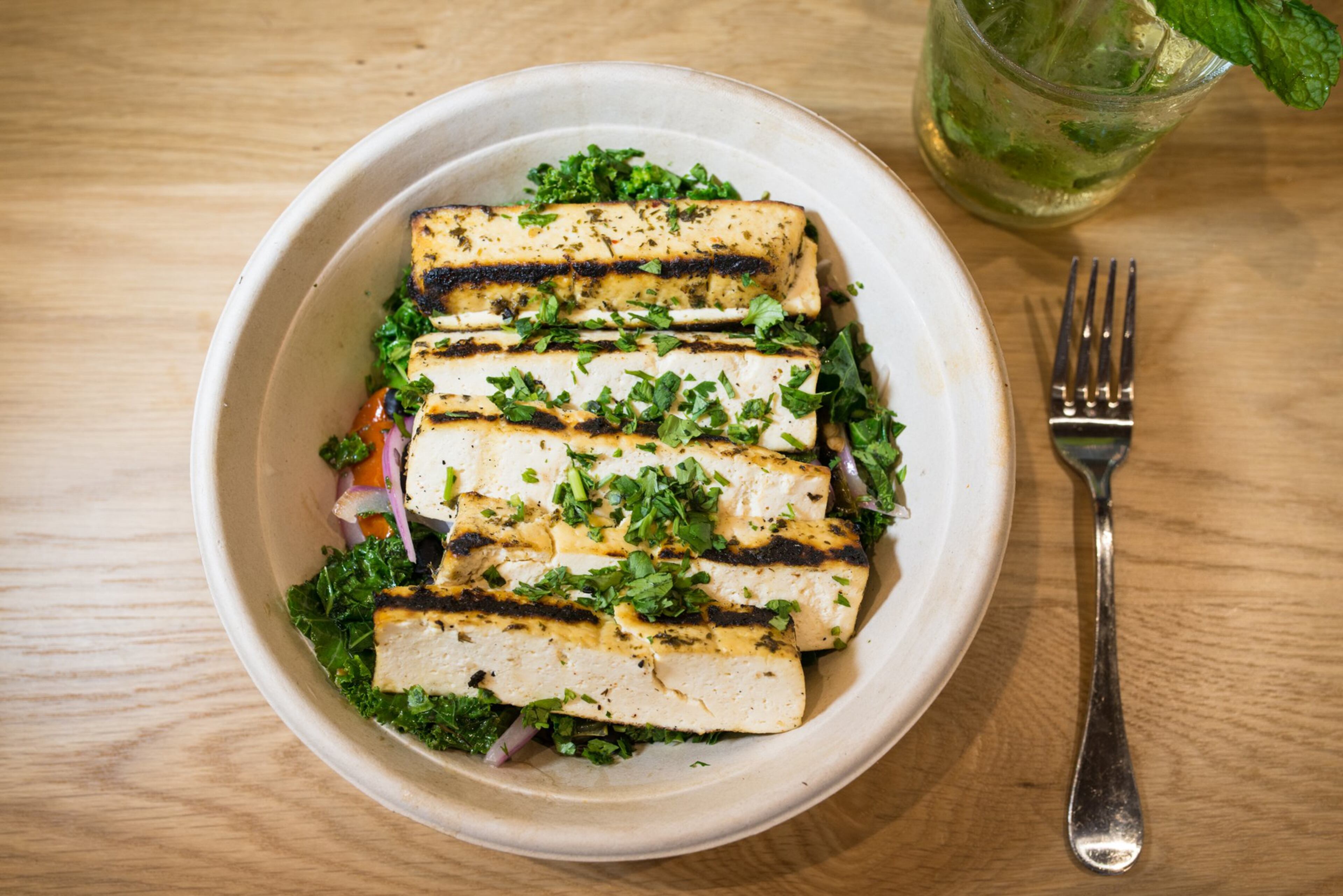 The Roast Charred Tofu bowl with rainbow chard, baked tofu, black beans, pepper, onion, fire roasted tomato, coconut milk, and cilantro./Photo credit- Mia Yakel.