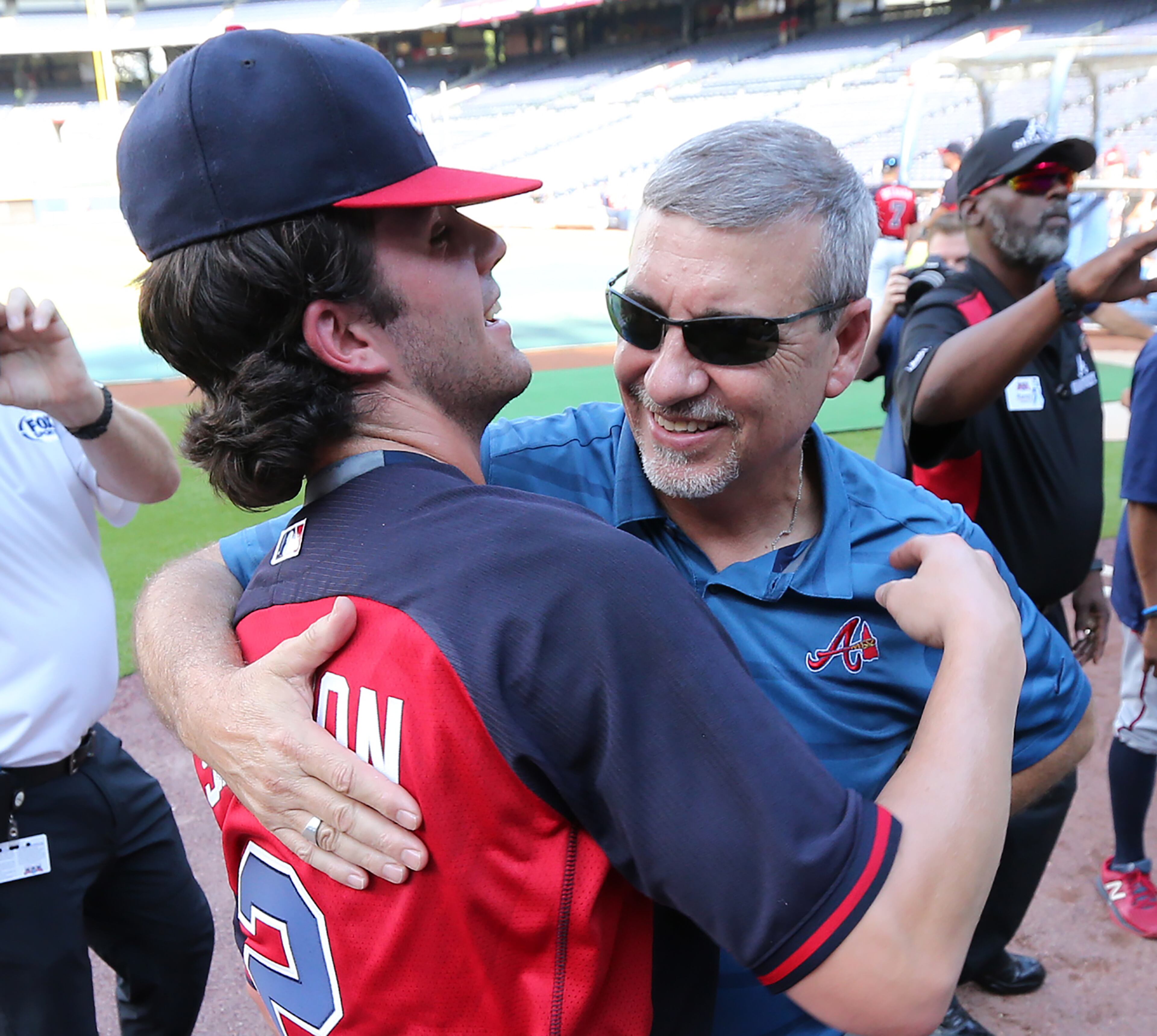 081716 ATLANTA: Braves top prospect Dansby Swanson gets a hug from his dad Cooter Swanson as he makes his MLB debut at Turner Field during batting practice before playing the Twins in a baseball game on Wednesday, August 17, 2016, in Atlanta. Curtis Compton /ccompton@ajc.com