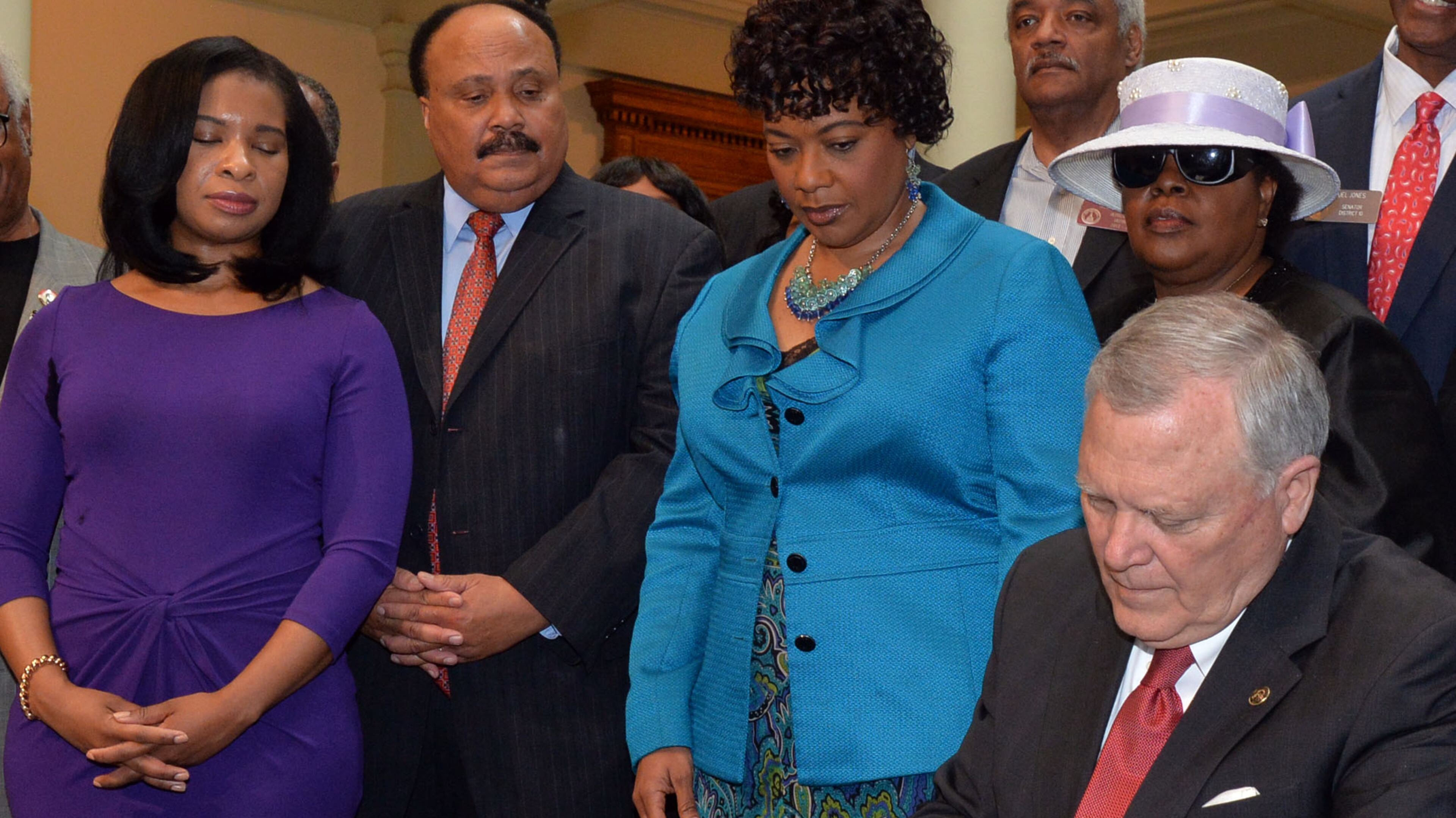 With Martin Luther King III, his wife, Arndrea, sister Bernice and members of the General Assembly looking on, Governor Nathan Deal signs legislation related to the Martin Luther King Jr. tribute statue (HB 1080) at the State Capitol Tuesday, April 29, 2014 -- the last day the governor can sign bills into law.
