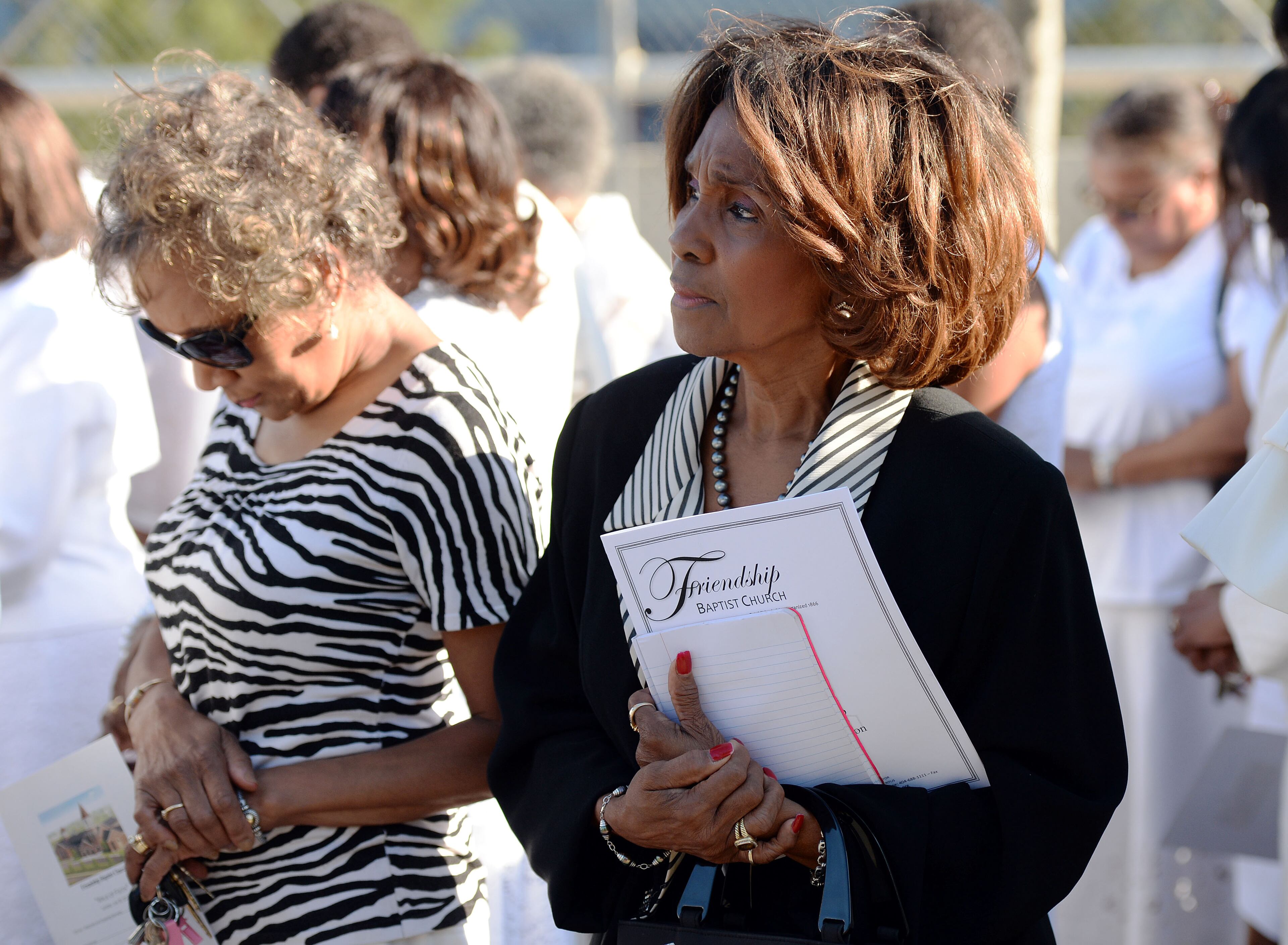 JULY 30, 2017 ATLANTA Church member Ruby Thomas or Decatur, listens as members prepare for a memorial march from the site of the old church to the new. Members attend the first morning worship service at Friendship Baptist Church Sunday, July 30, 2017. The 155-year old historic church, which started out as the home for both Morehouse and Spelman Colleges, was rebuilt after their former building was demolished to make way for the Falcons' Mercedes-Benz Stadium. KENT D. JOHNSON / AJC