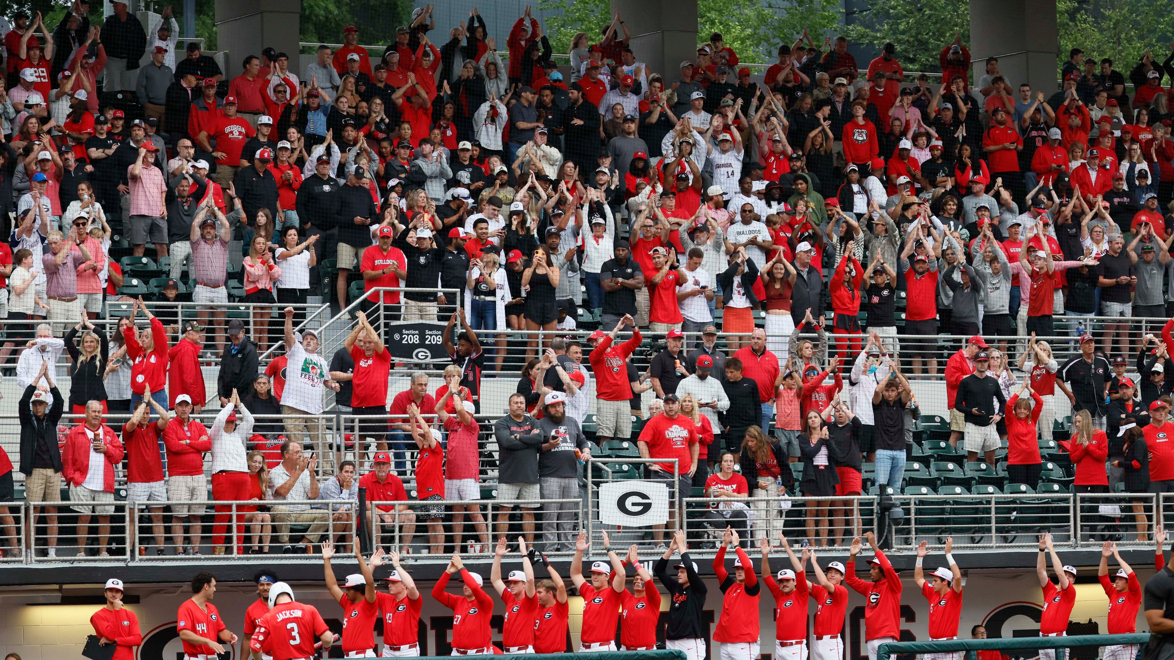 Georgia Bulldogs fans and players cheer as the Liberty Flames change pitchers during the eighth inning Sunday, May 31, 2026, in Athens. (Miguel Martinez/AJC)