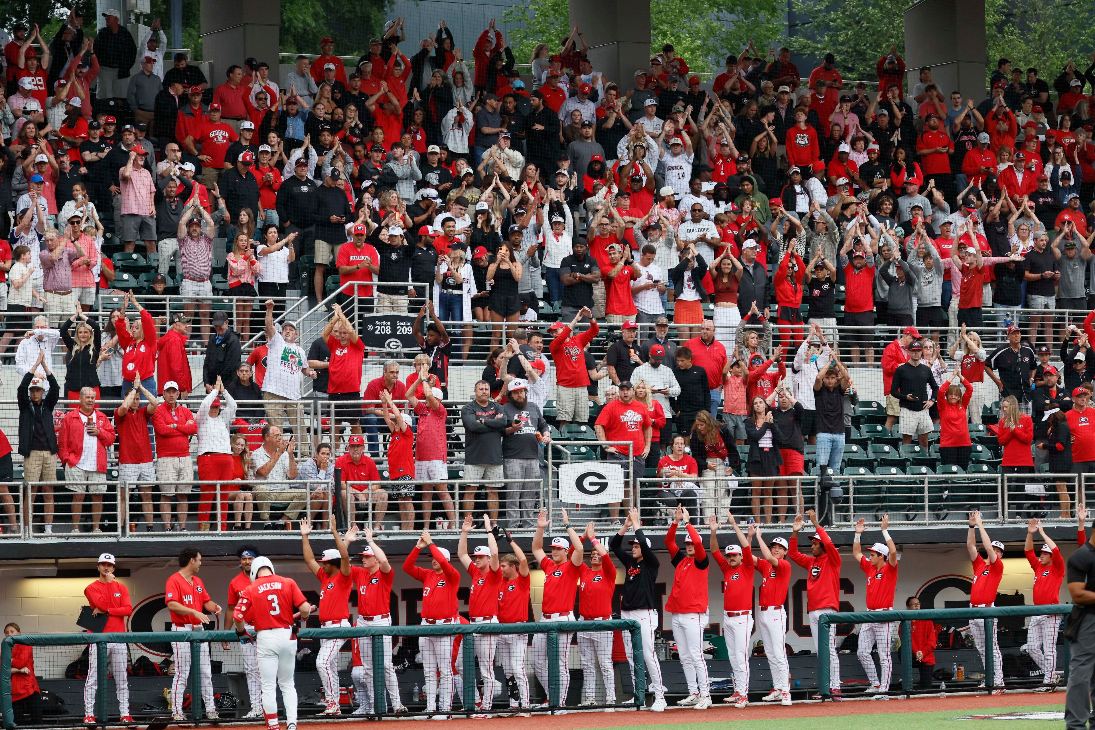 Gergia Bulldogs fans and players cheer as Liberty Flames exange pitcher during the eighth inning of their NCAA Regional final game at Foley Field on Sunday, May 31, 2026, in Athens.(Miguel Martinez/AJC)