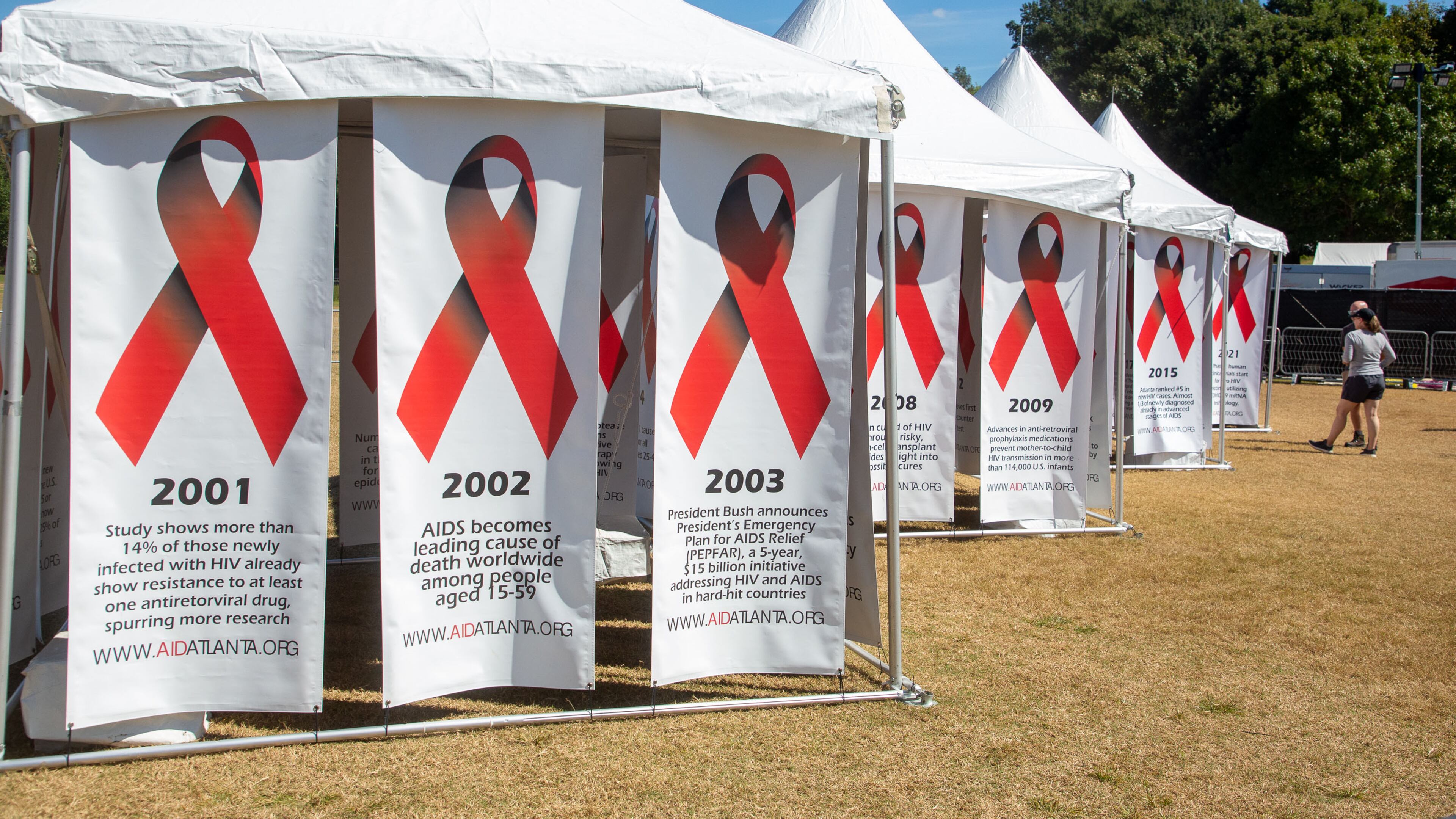 People look over the historical banners during the annual AIDS Walk Atlanta in Piedmont Park on Saturday, September 25, 2021. (Photo: Steve Schaefer for The Atlanta Journal-Constitution)