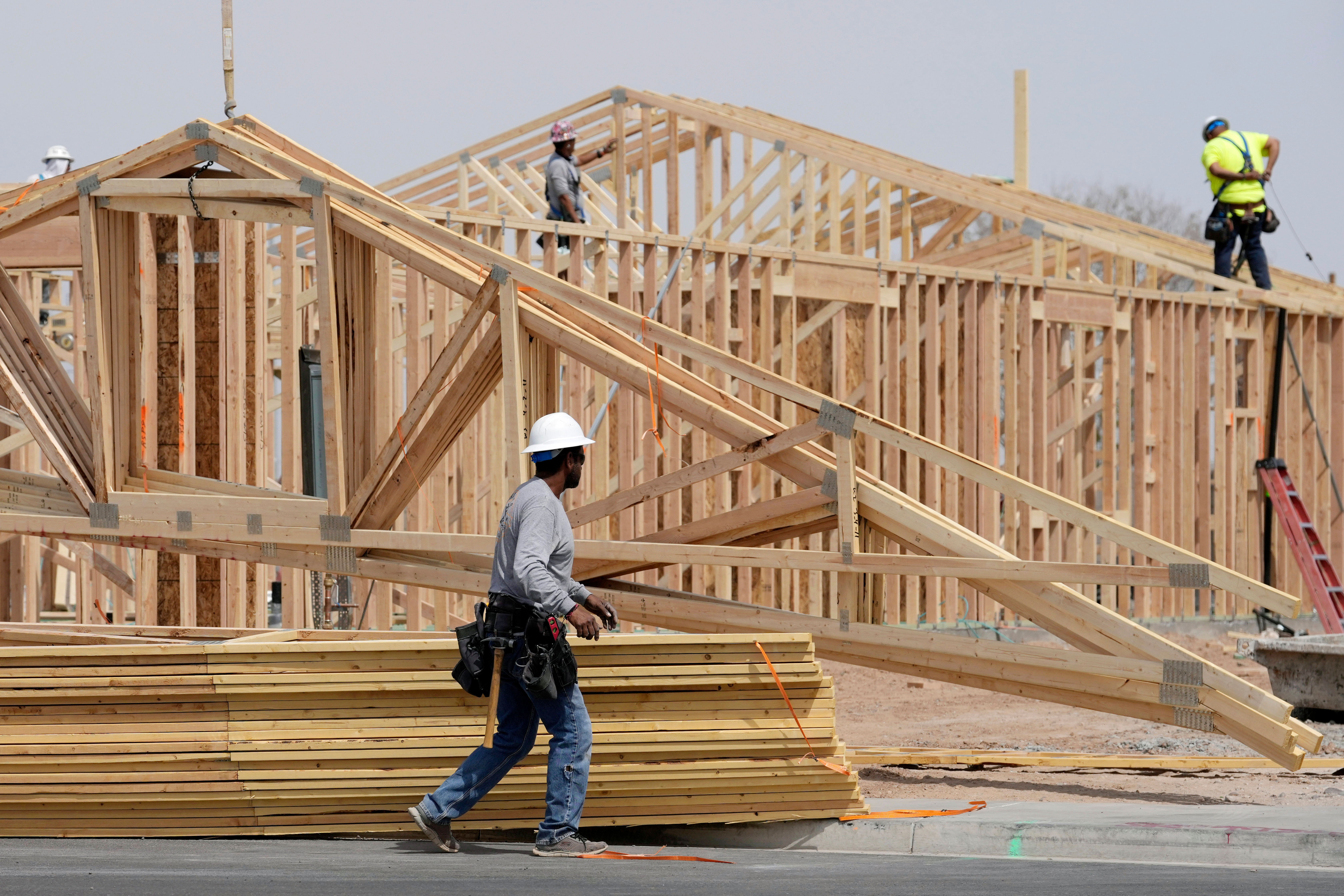 FILE - Construction workers install a lumber roof at a new home build Tuesday, April 1, 2025, in Laveen, Ariz. (AP Photo/Ross D. Franklin, File)
